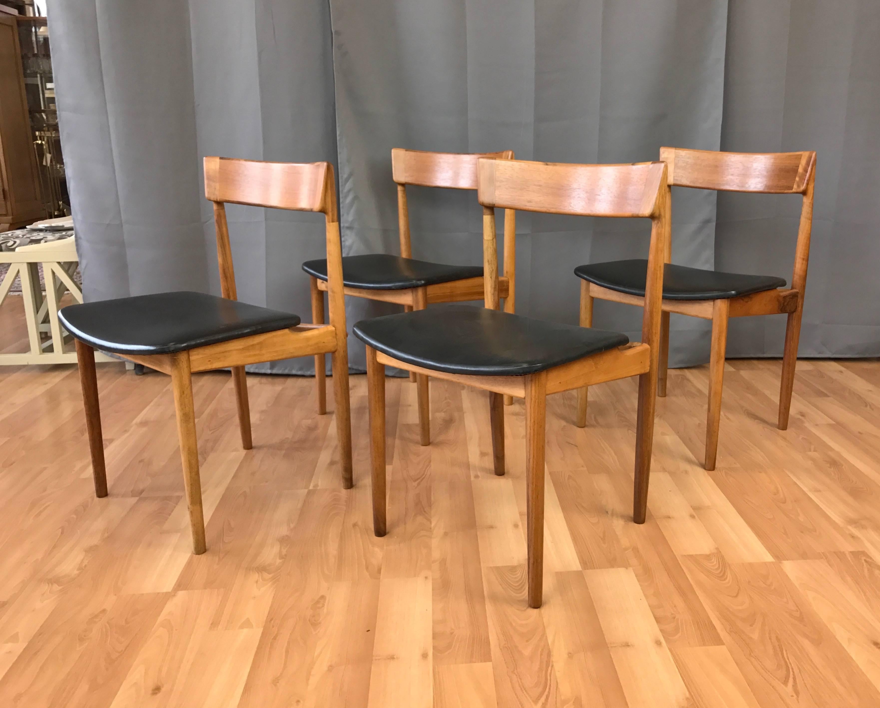 A four-piece set of Model 39 Teak dining or side chairs by Henry Rosengren Hansen for Brande Møbelindustri. 

A Classic Danish modern design in solid teak that features a distinctive sculptural seat back. Upholstered in original black