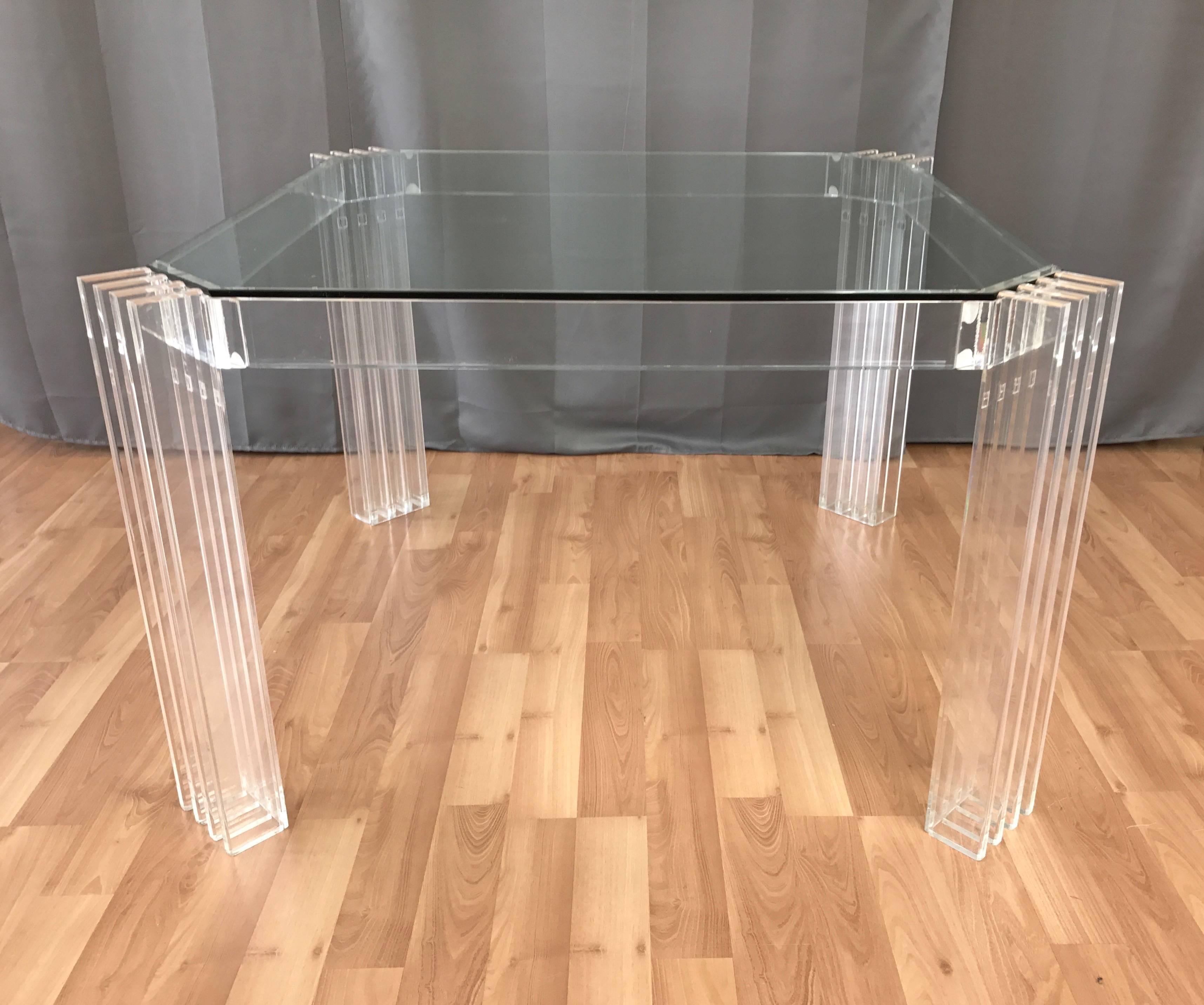 A striking 1970s square Lucite dining table or large game table with glass top by Charles Hollis Jones.

Uncommon and impeccably executed design is effortlessly contemporary, with no metal hardware to detract from its crystal clear appearance.