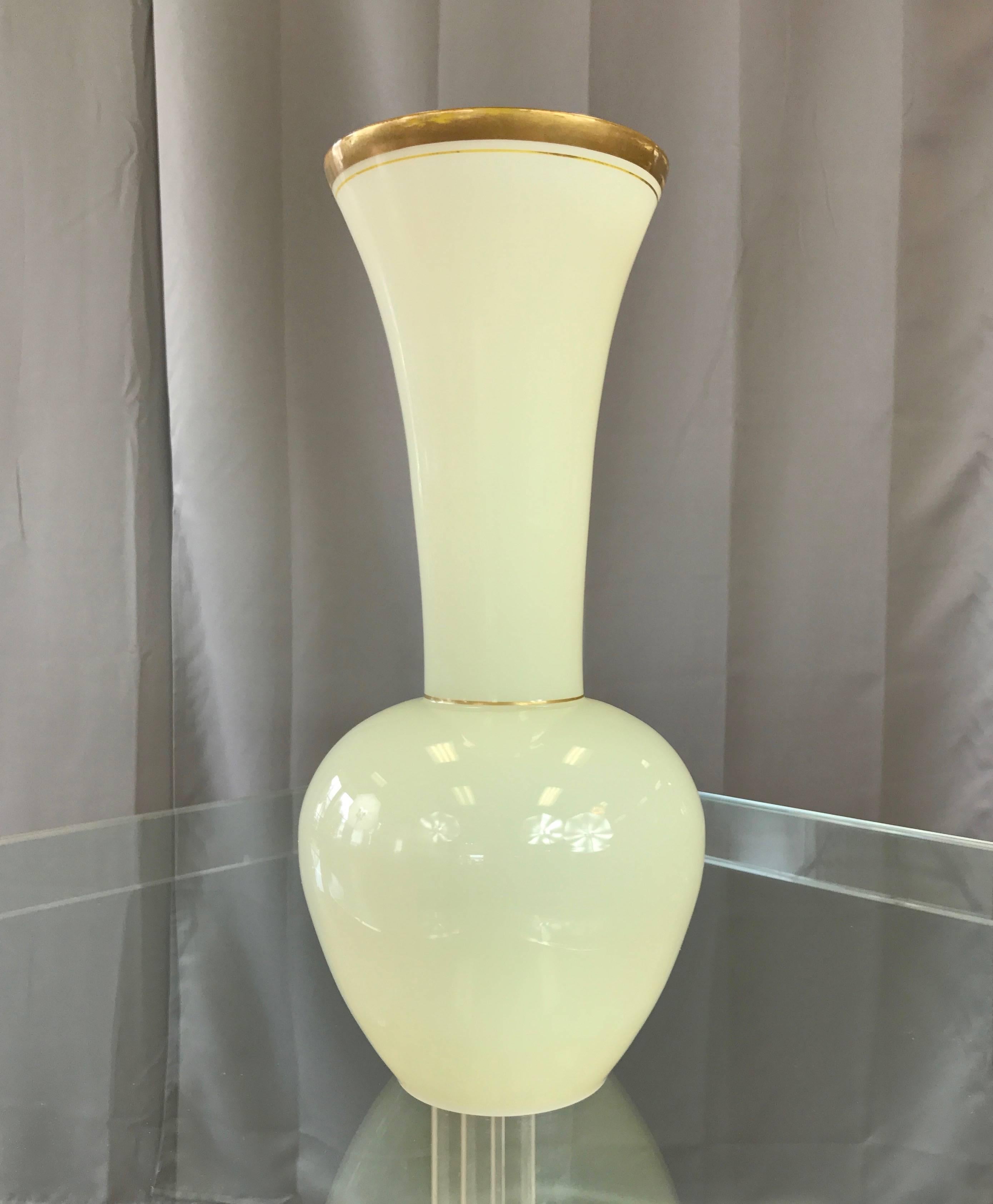A gorgeous pale green opaline tall trumpet vase by Murano glass studio Cenedese.

Large handblown body has a lovely, jade-like luminosity. Hand-painted gilt band and pinstripe at mouth, with a second pinstripe at waist. Polished bottom. Unsigned.