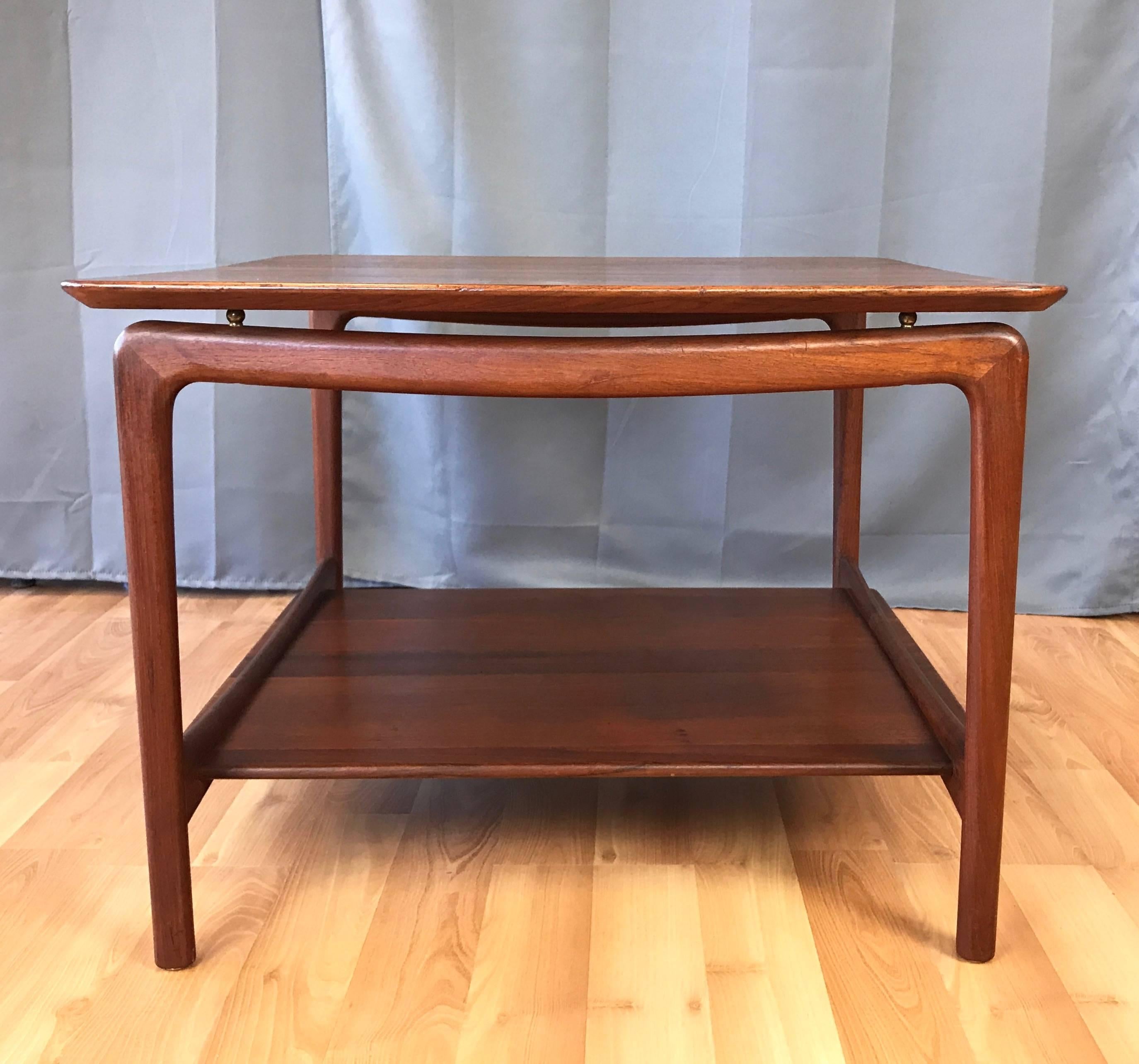 A midcentury Danish floating top teak side or coffee table by Peter Hvidt and Orla Mølgaard-Nielsen for France & Daverkosen, and originally retailed by John Stuart.

Solid teak knife edge top appears to float above a sculptural solid teak base