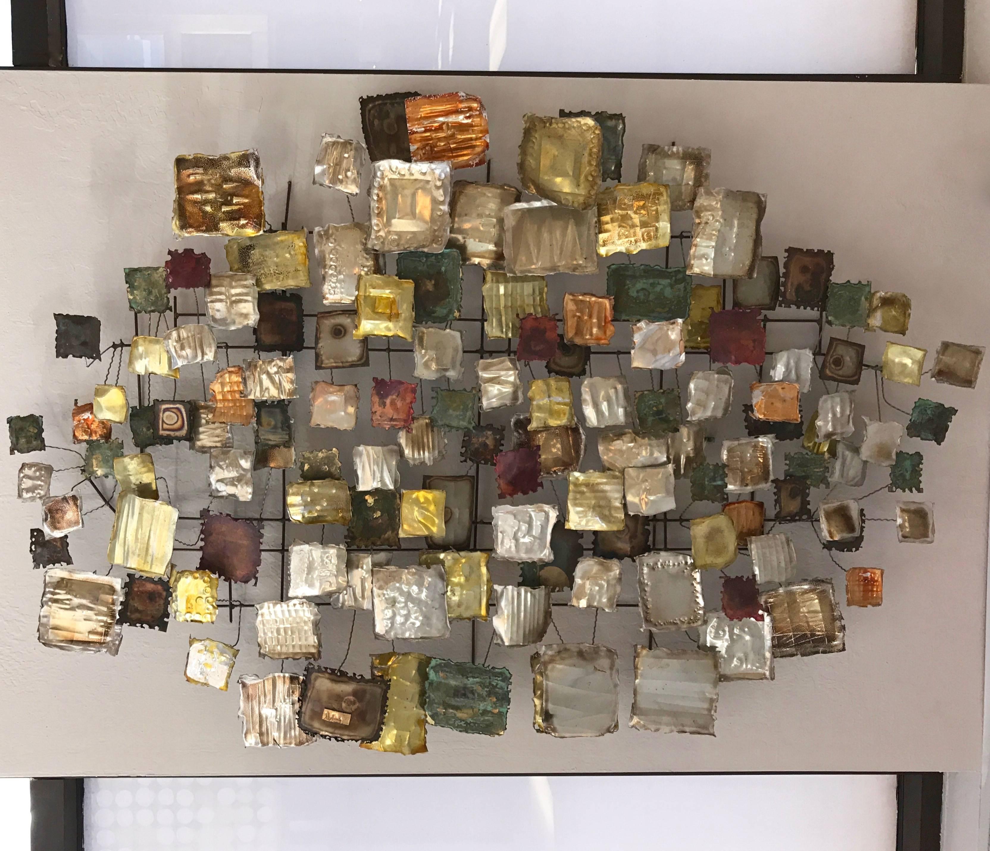 An impressively-sized Brutalist-style metal wall sculpture by California artist and Frank Lloyd Wright Memorial Award-winner Tony Melendy.

Comprised of more than one hundred square and rectangular tin, brass, and copper forms of varying sizes