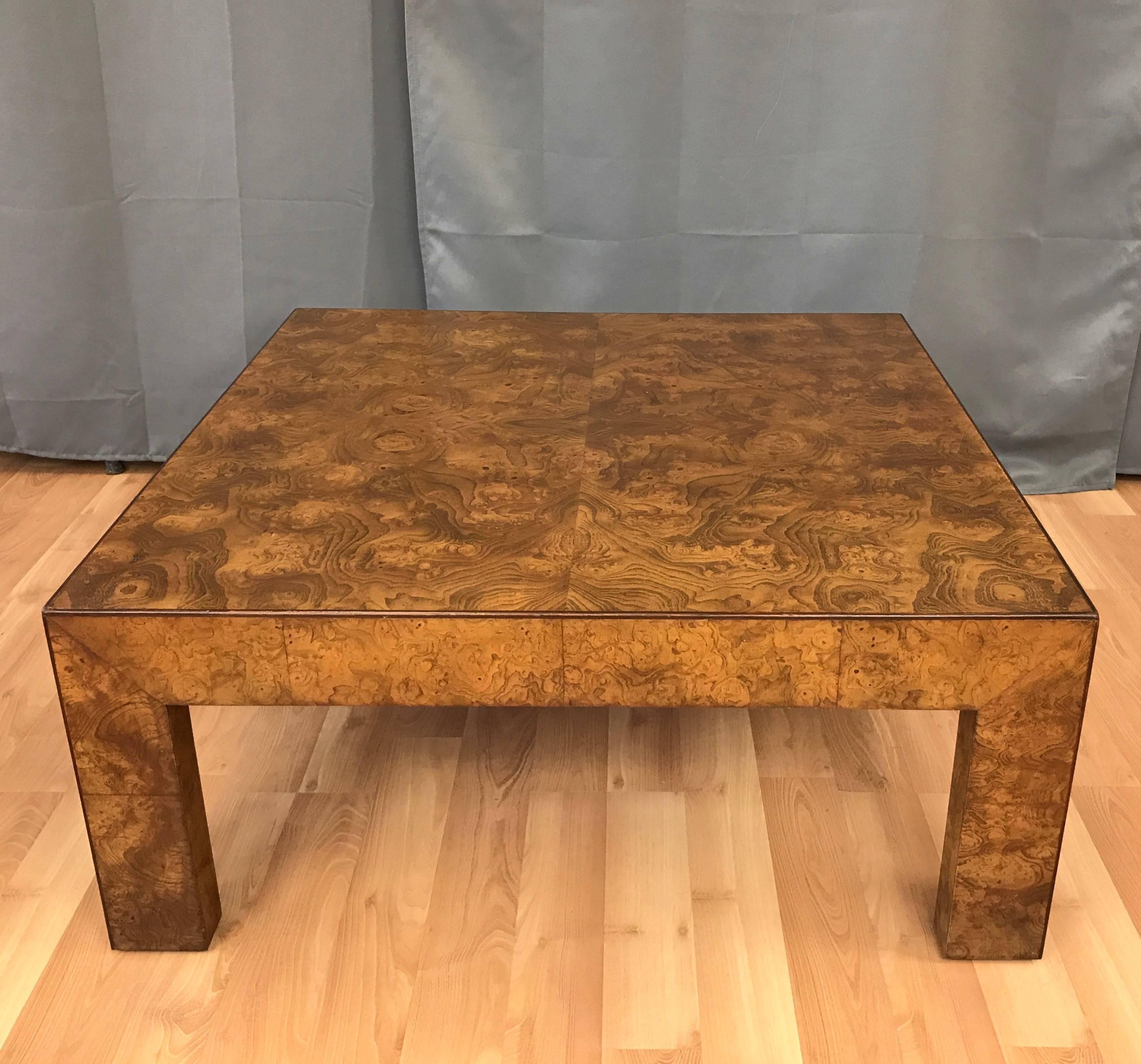 An uncommon and expansive elm burl coffee table by John Widdicomb Co.

Stoutly simple, perfectly proportioned form finished in dazzling elm burl veneer that evokes topographical maps, molten metal, or a Rorschach test writ large. Pentagonal legs