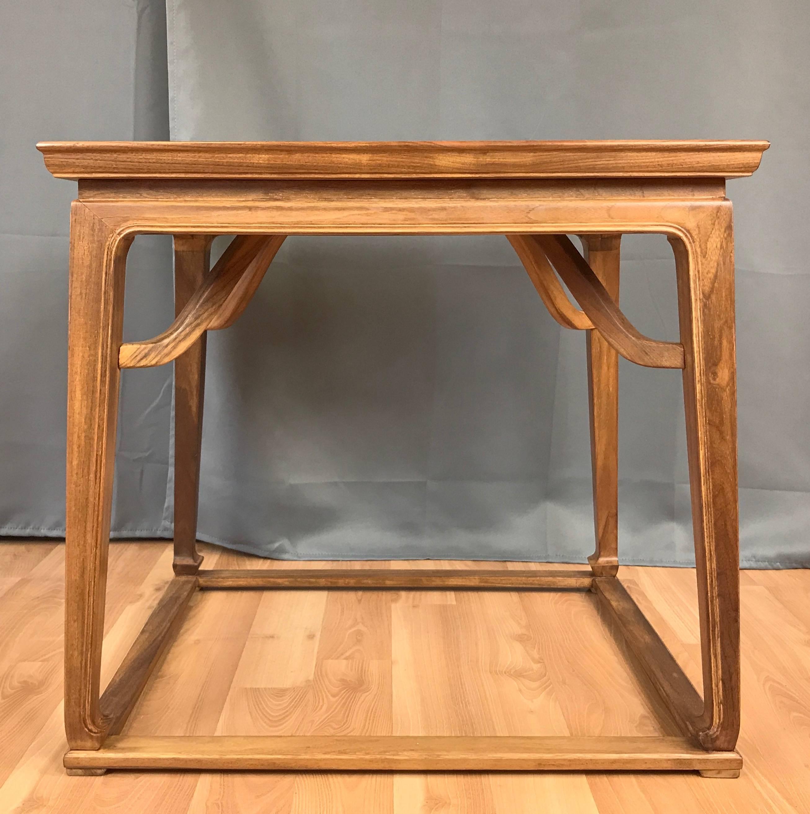 A mid-century chinoiserie-style walnut side table by Michael Taylor for Baker Furniture.

Solid walnut frame has understated Asian design cues, including its beveled edge top, decorative brackets, and gracefully tapered legs terminating in