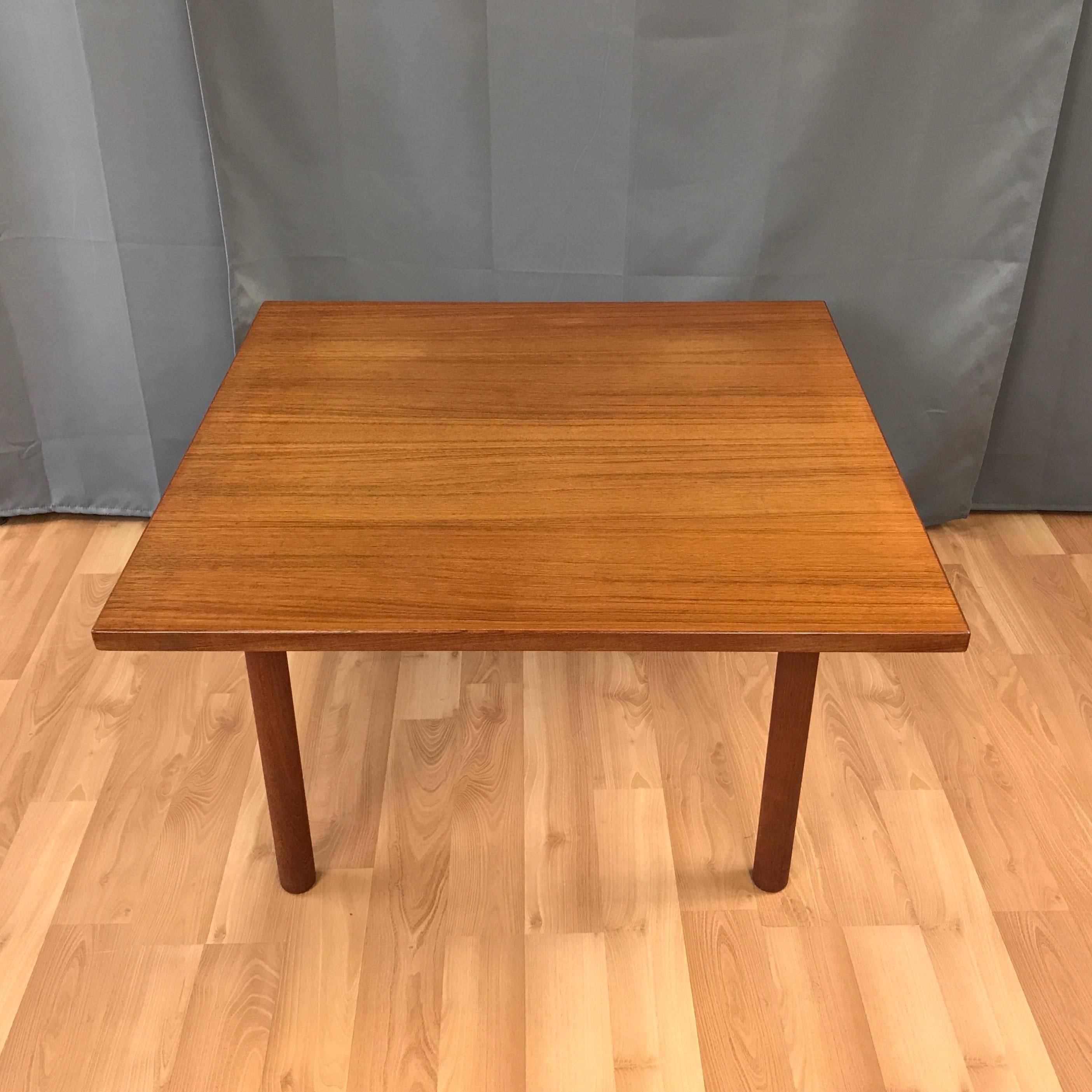 An uncommon Danish modern teak cocktail or coffee table by Hans J. Wegner for GETAMA.

Spacious teak veneer square top is supported by sturdy solid teak flared dowel legs. A pure and timeless design well-suited for both midcentury and modern