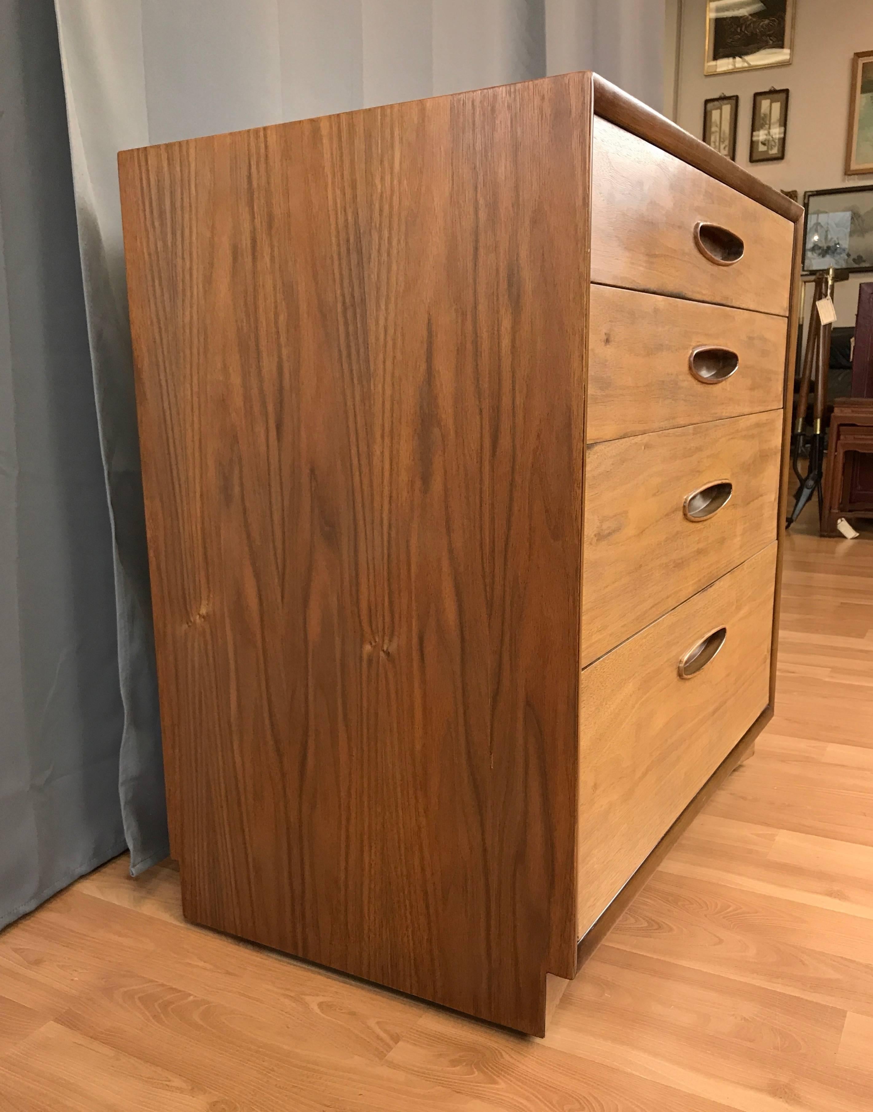 A four-drawer walnut bachelor’s chest from Henredon’s mid-century modern “Circa ’60 Collection”.

Introduced in the 1950s, Henredon’s ads from that time described their forward-looking “Circa ’60 Collection” as being “designed to blend with any