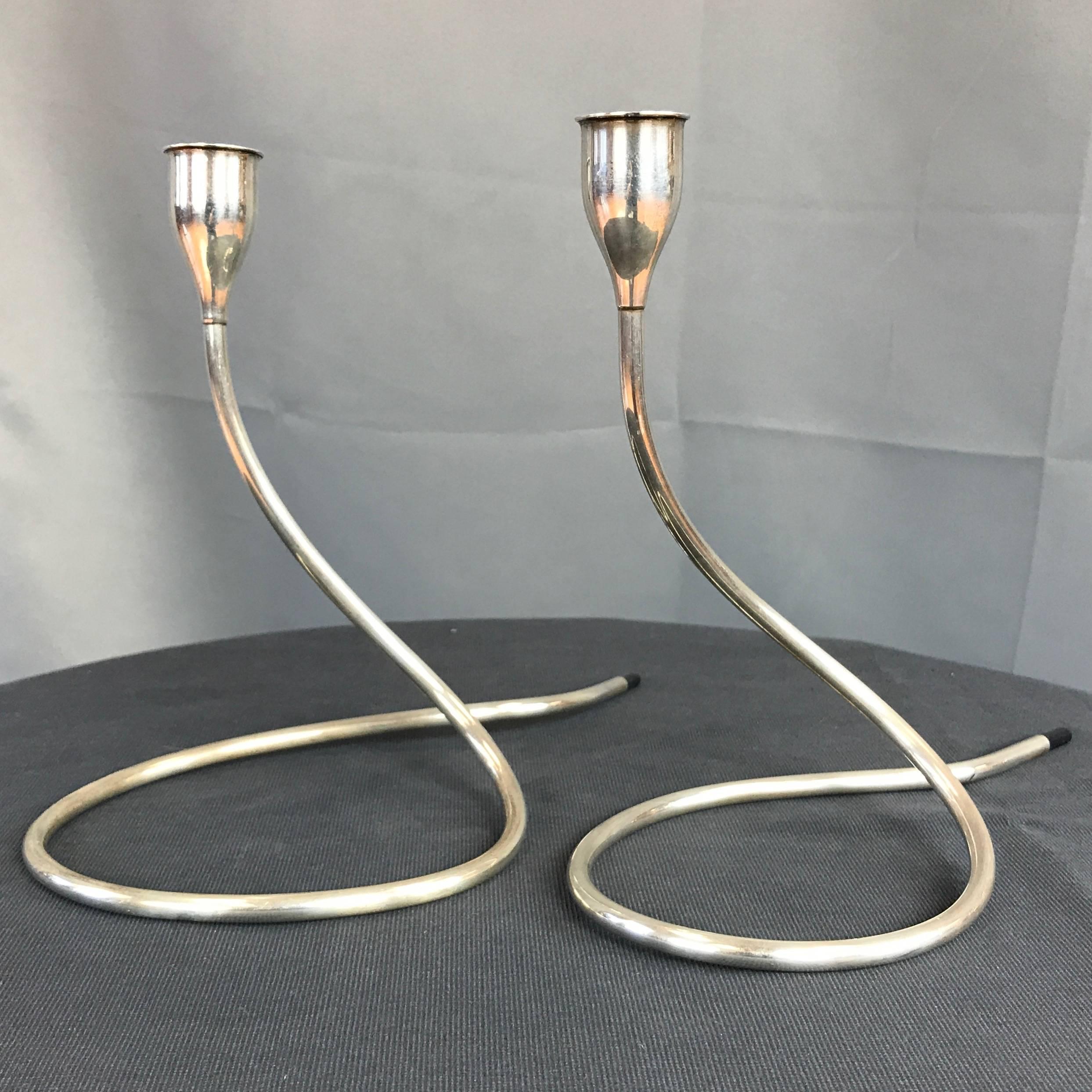 A pair of sterling silver candleholders by Marion Anderson Noyes for Towle.

Very elegant serpentine design evokes a coiled cobra with a sleek head and plastic tipped tail. “TOWLE STERLING – 11 – FILLED REINFORCED” impressed on interior bottom of