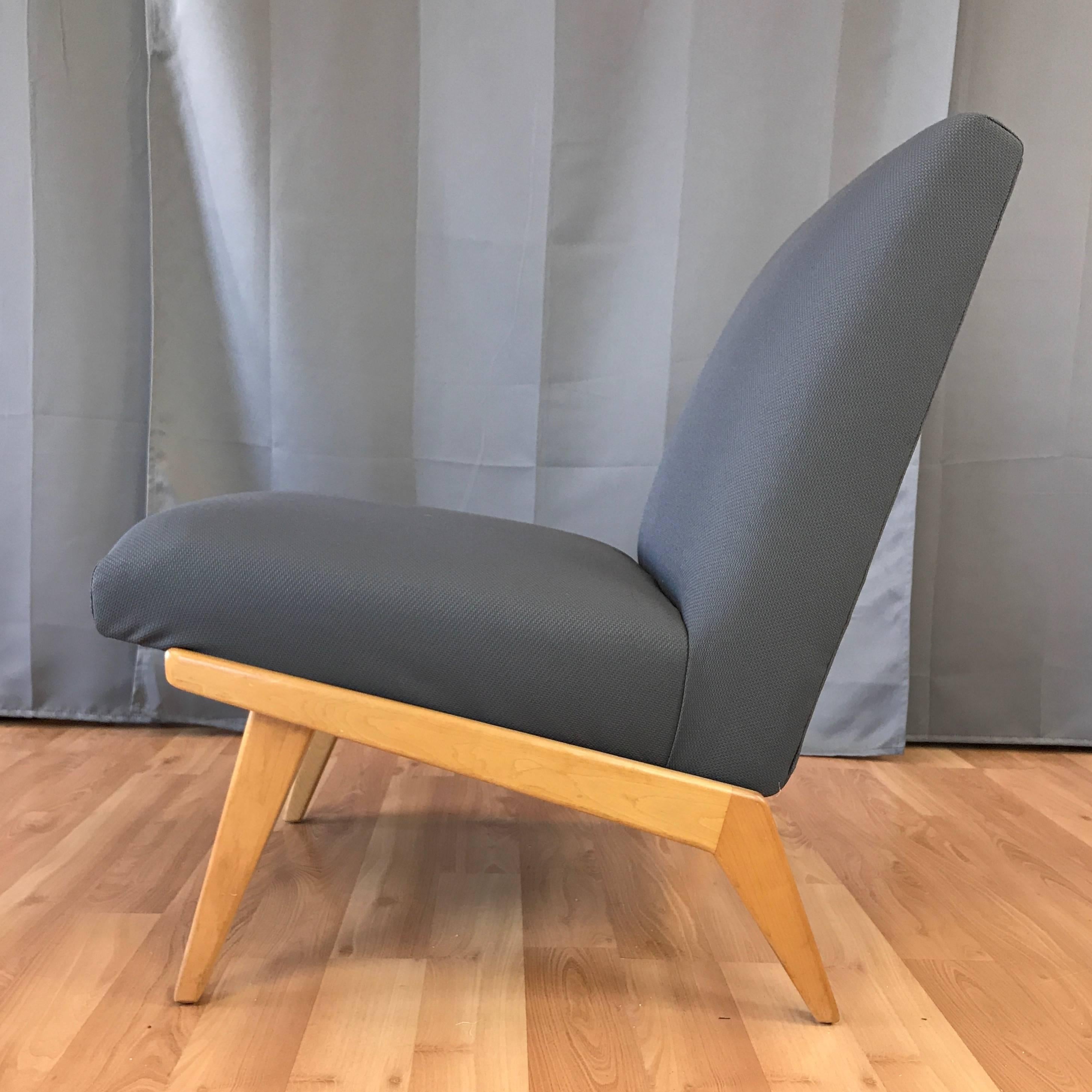 A streamlined slipper or armless lounge chair designed in 1946 by Jens Risom for Knoll Associates. Low-slung boomerang-leg base in solid maple. Newly reupholstered in handsome cool-hued grey basketweave.

Seat height is 17