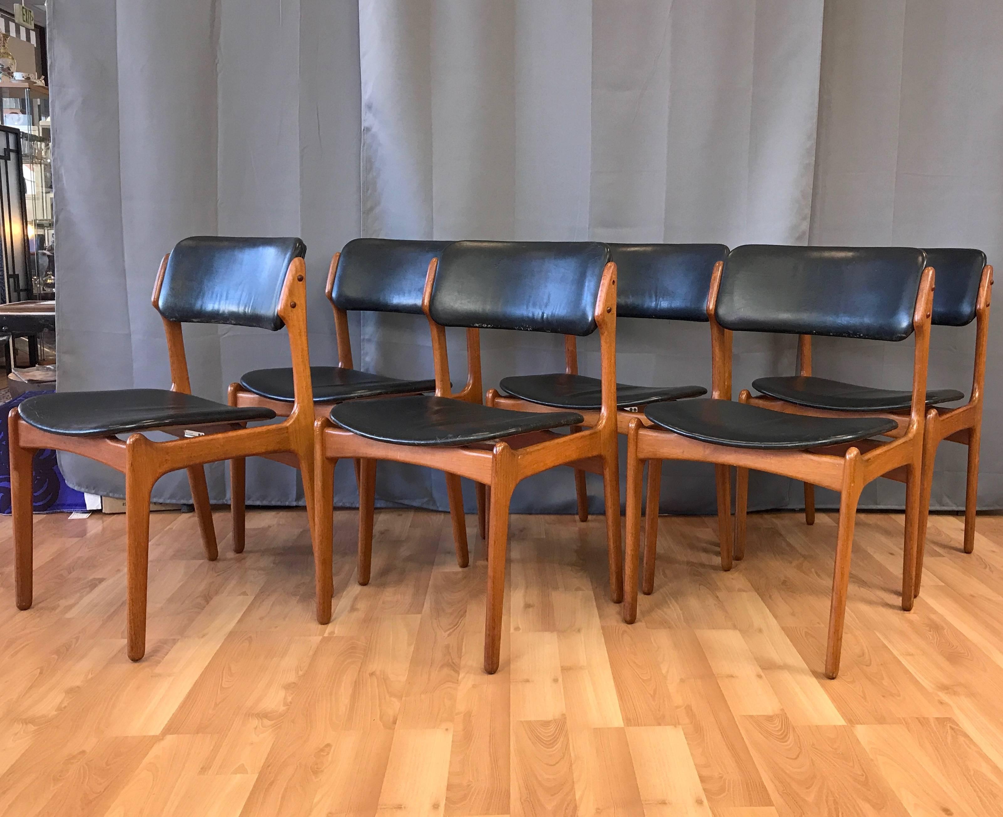 A six-piece set of classic Danish OD-49 teak and leather dining chairs by Erik Buch for O.D. Møbler (Oddense Maskinsnedkeri).

Solid teak frame distinguished by assertive, smoothly sculpted lines. Distinctive thin floating seat and canted back are