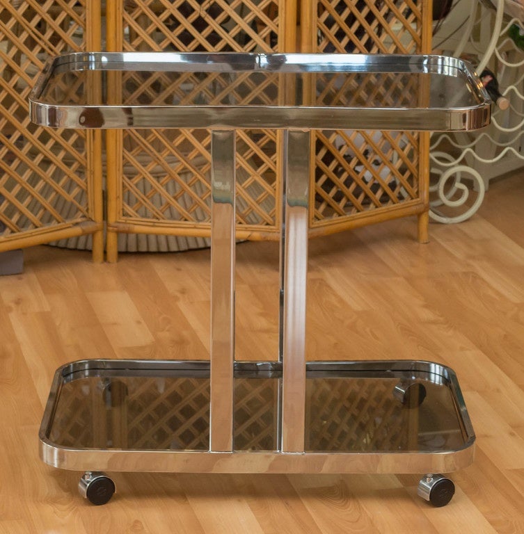 A vintage two-tier flat bar, chrome bar cart, on a set of four casters, circa 1970s, by Milo Baughman