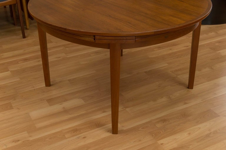 Dyrlund Danish modern Teak dining table table, called a Flip Flap or Lotus table referring the hinged leaves.  Easily go from a small dinner party to a large party.
47 inches across without leaves, 69 inches with leaves.