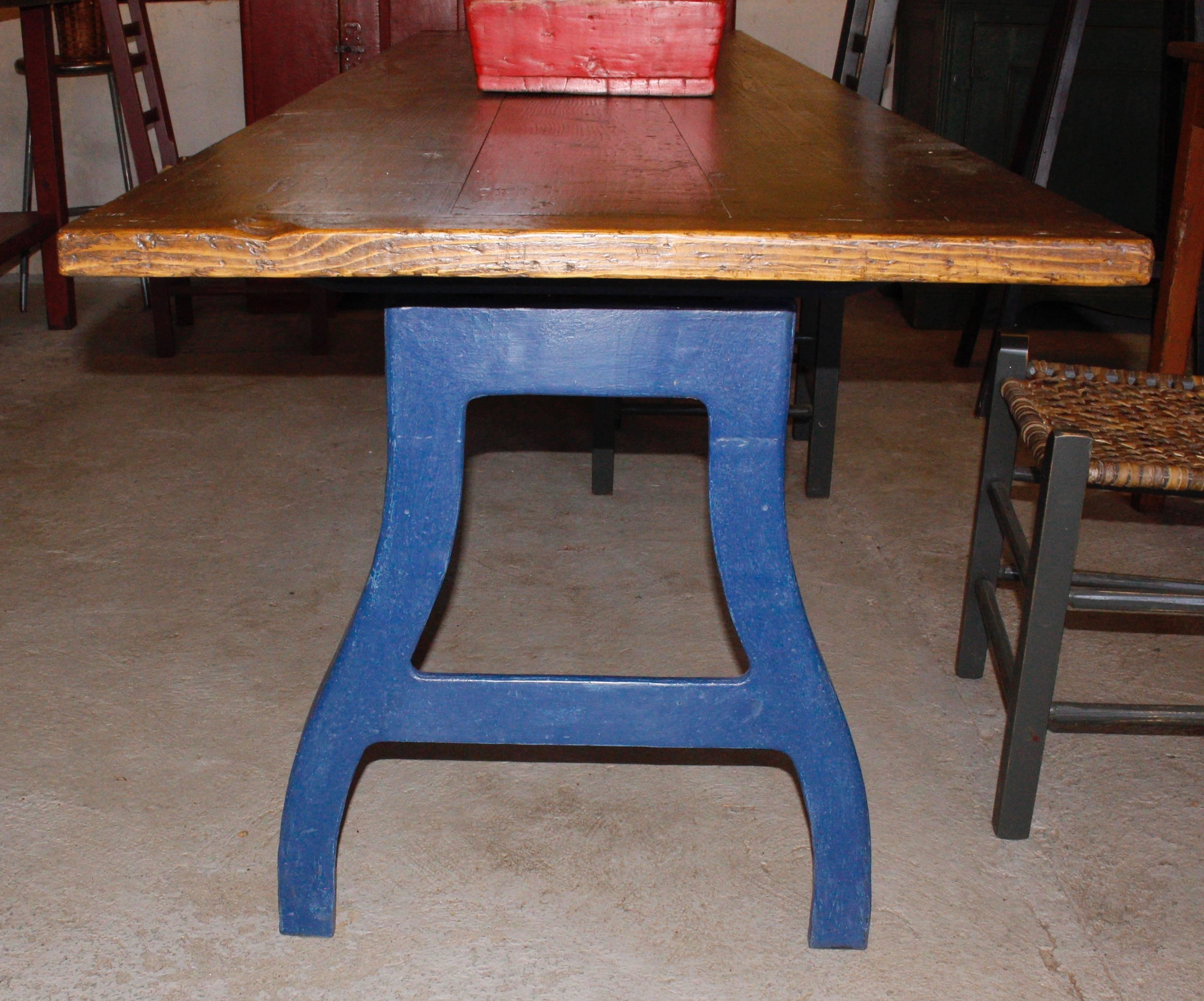 A long work table found in a factory.  Iron base, wood top