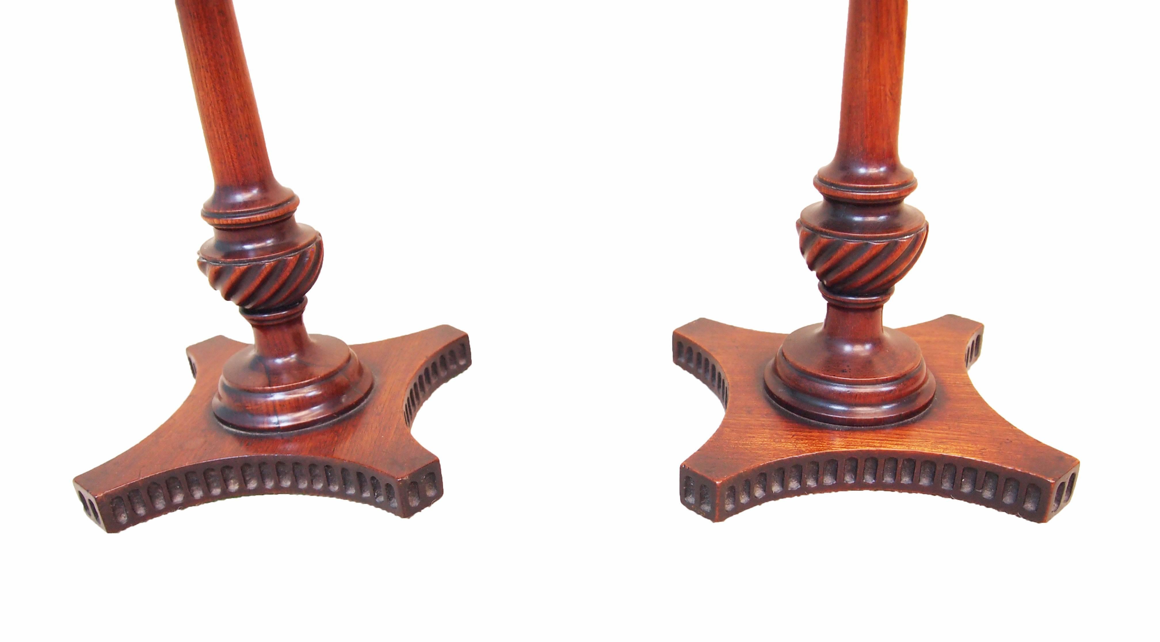 A fine pair of late 18th century mahogany candlestands having well figured
circular dish tops raised on turned central columns with crisply carved
wrythen decoration terminating on quad form base with
elegant fluted decoration.