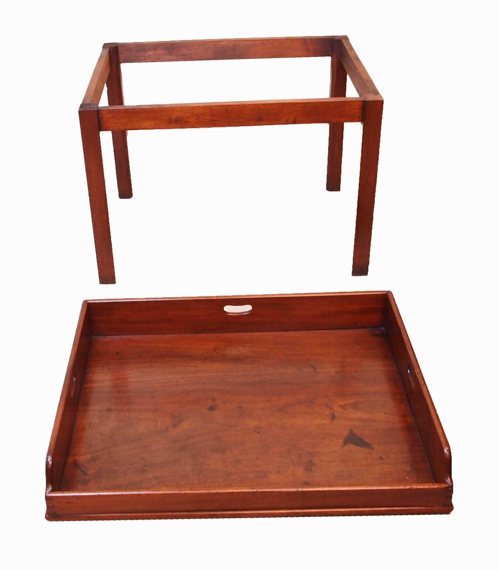 A good quality late 18th century mahogany butlers tray of excellent color
and patina having pierced handles to gallery top housed on later square
chamfered leg mahogany stand.