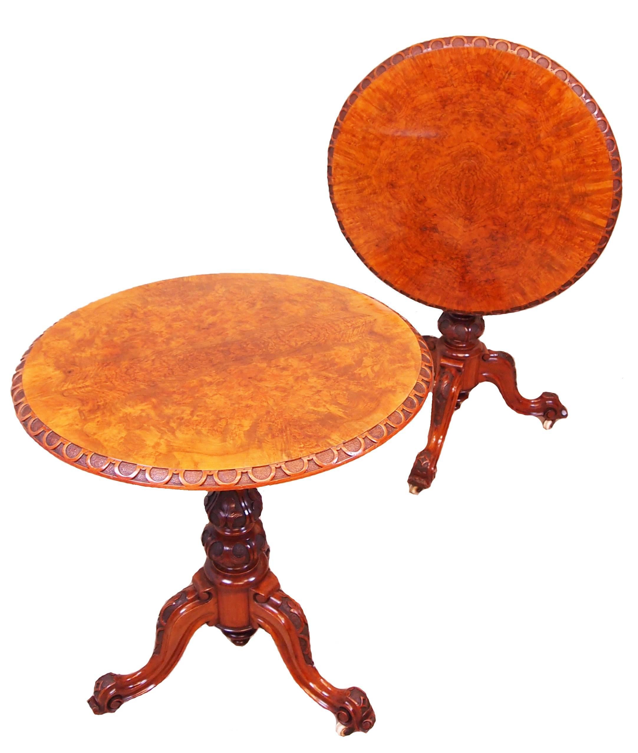 A superb quality and extremely rare pair of mid-19th century burr walnut
lamp tables having superbly figured burr walnut circular tops, one tilting,
with blind fretwork carved decoration to edges raised on carved central
columns terminating on