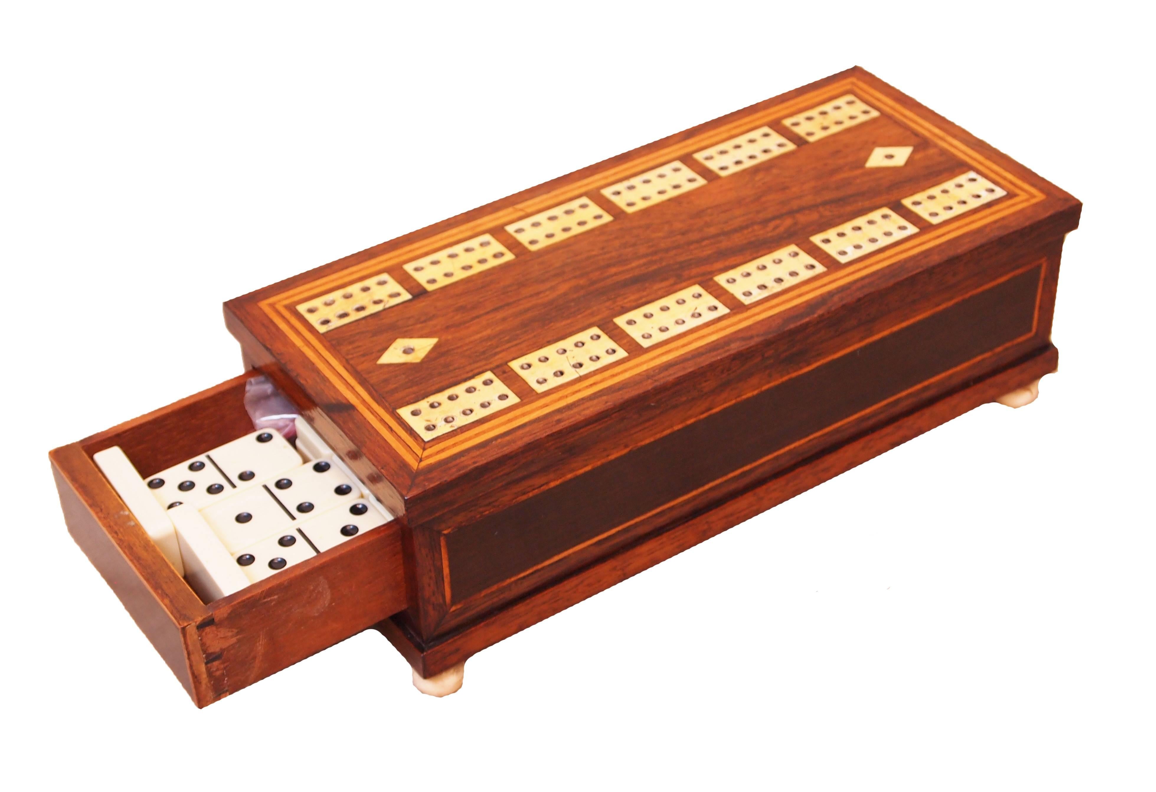 A delightful and exceptional quality regency rosewood dominoes
Games box having attractive inlaid decoration and concealed end
Drawer with secret push button opening.