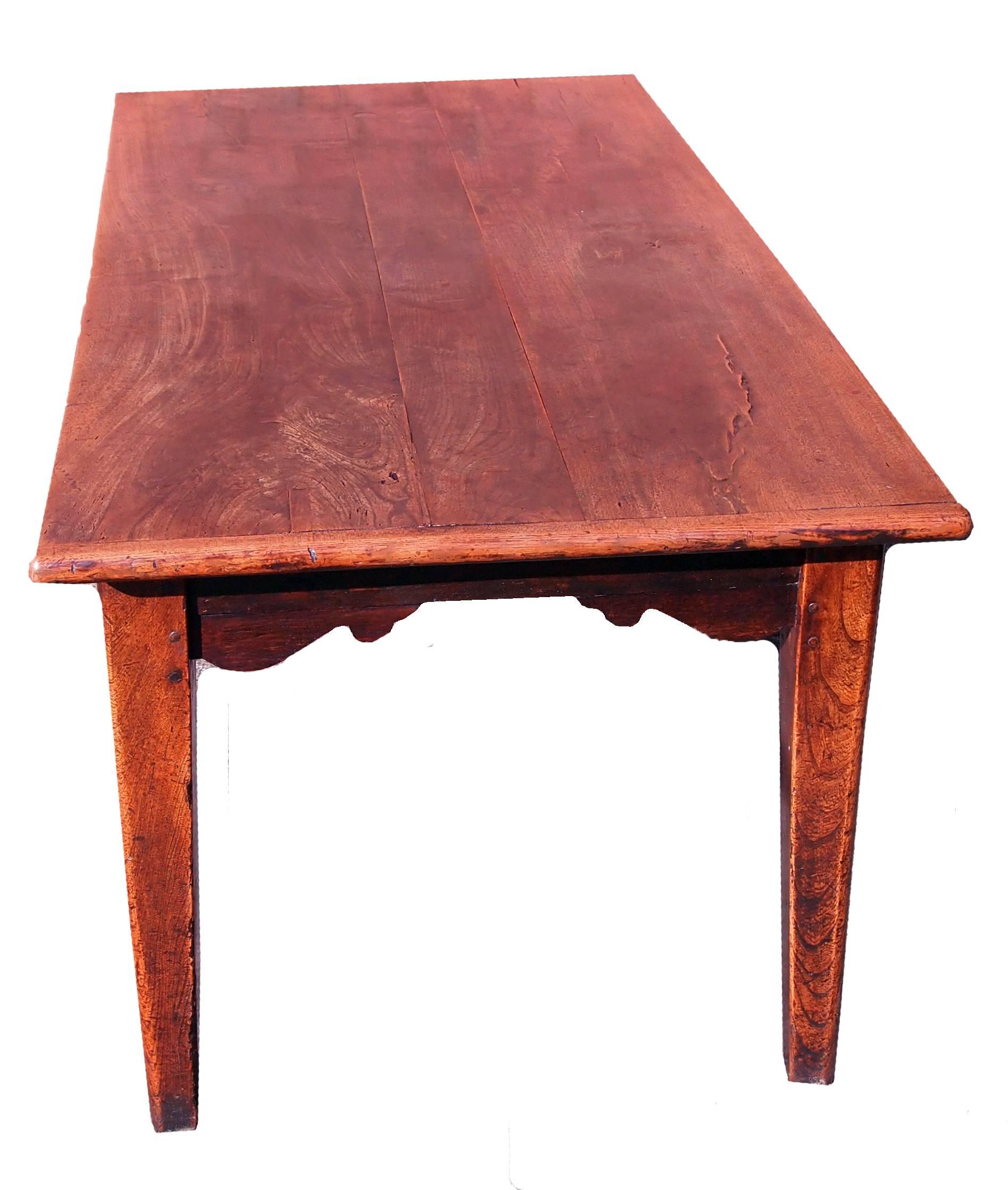 A stunning early 19th century French elm farmhouse table having superbly
figured plank top with cleated ends raised on attractive square tapered
legs retaining exceptional color and patina throughout.

 