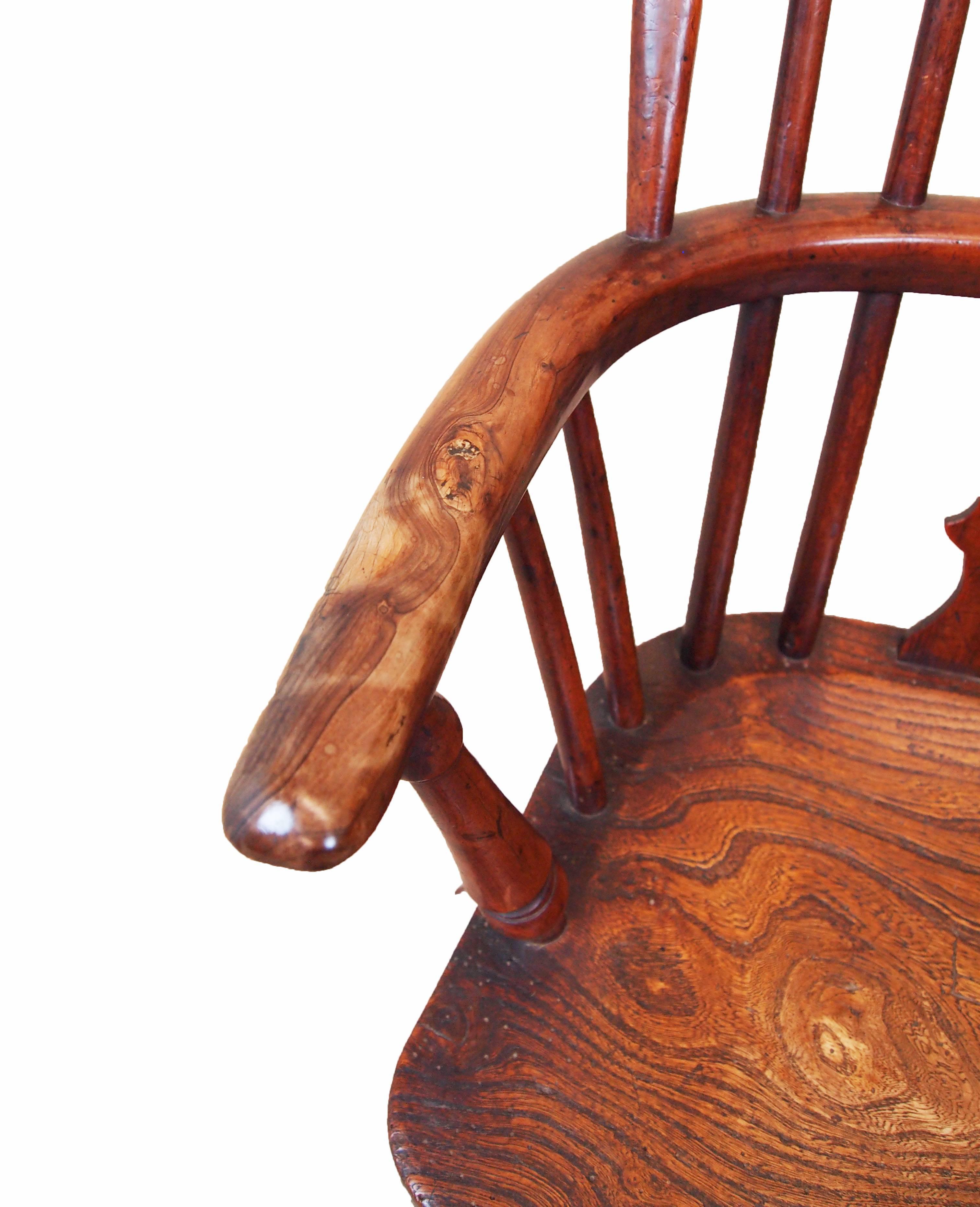 A delightful 19th century yew, ash and elm child's size windsor armchair having
attractive pierced splat back raised on turned legs united by crinoline
stretcher.