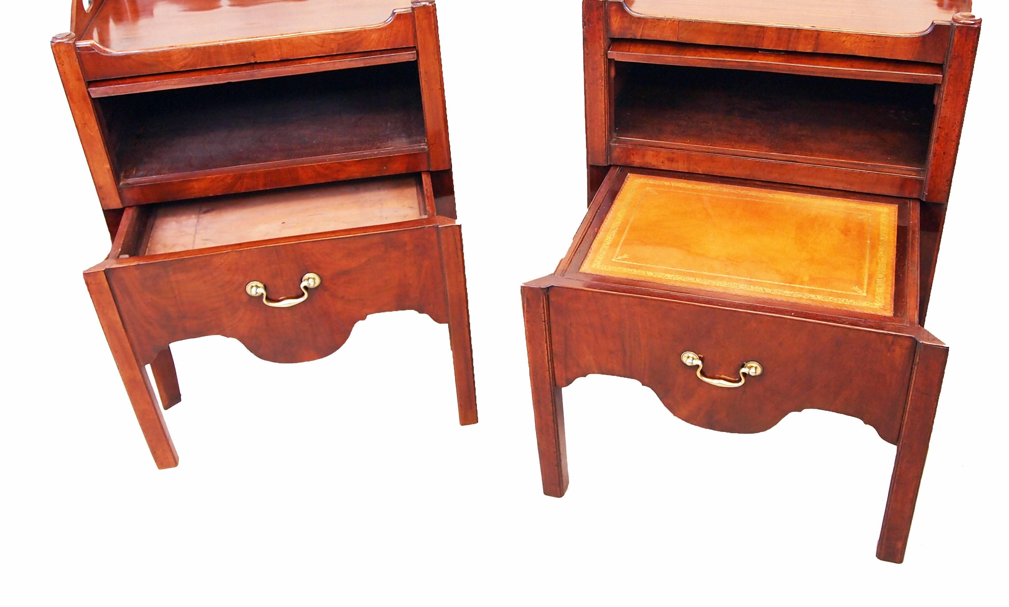 An extremely well matched pair of 18th century mahogany tray top
commodes, or bedside night tables, having well figured tops with shaped
galleries and pierced handles above up and over cupboard doors and
converted drawers with original brass swan