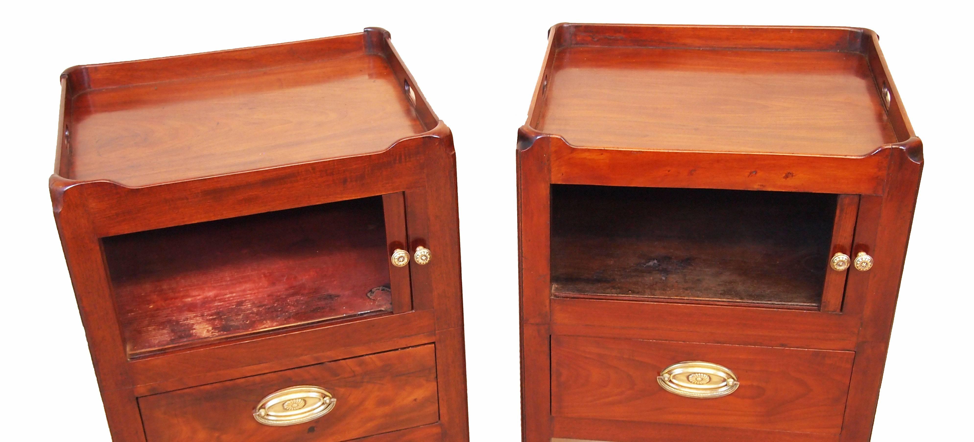 An exceptionally close matching pair of George III period 
Mahogany tray top commodes, or bedside tables, having
Well figured gallery tops above tambour doors and 
Converted drawers raised on square chamfered legs.