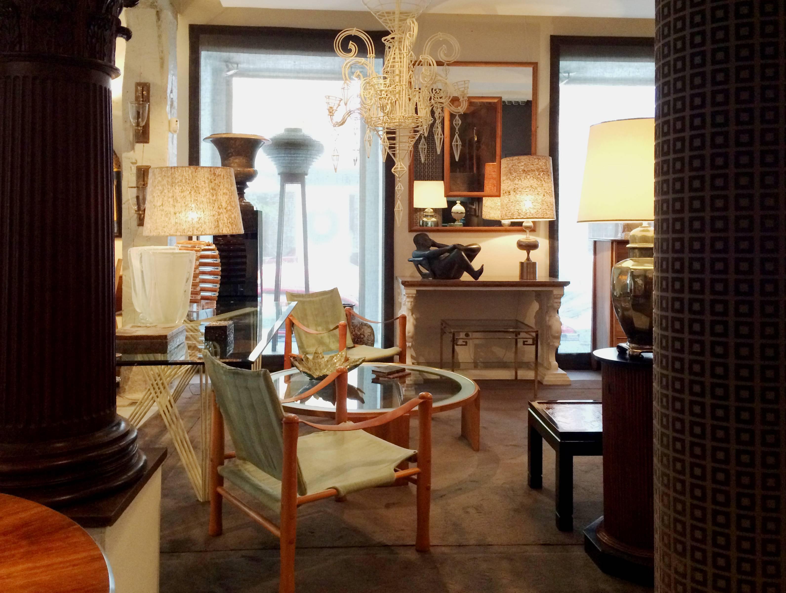 A large modernist-style round coffee table in oakwood, ebony marquetry, gilded metal and an acid-worked glass top.

