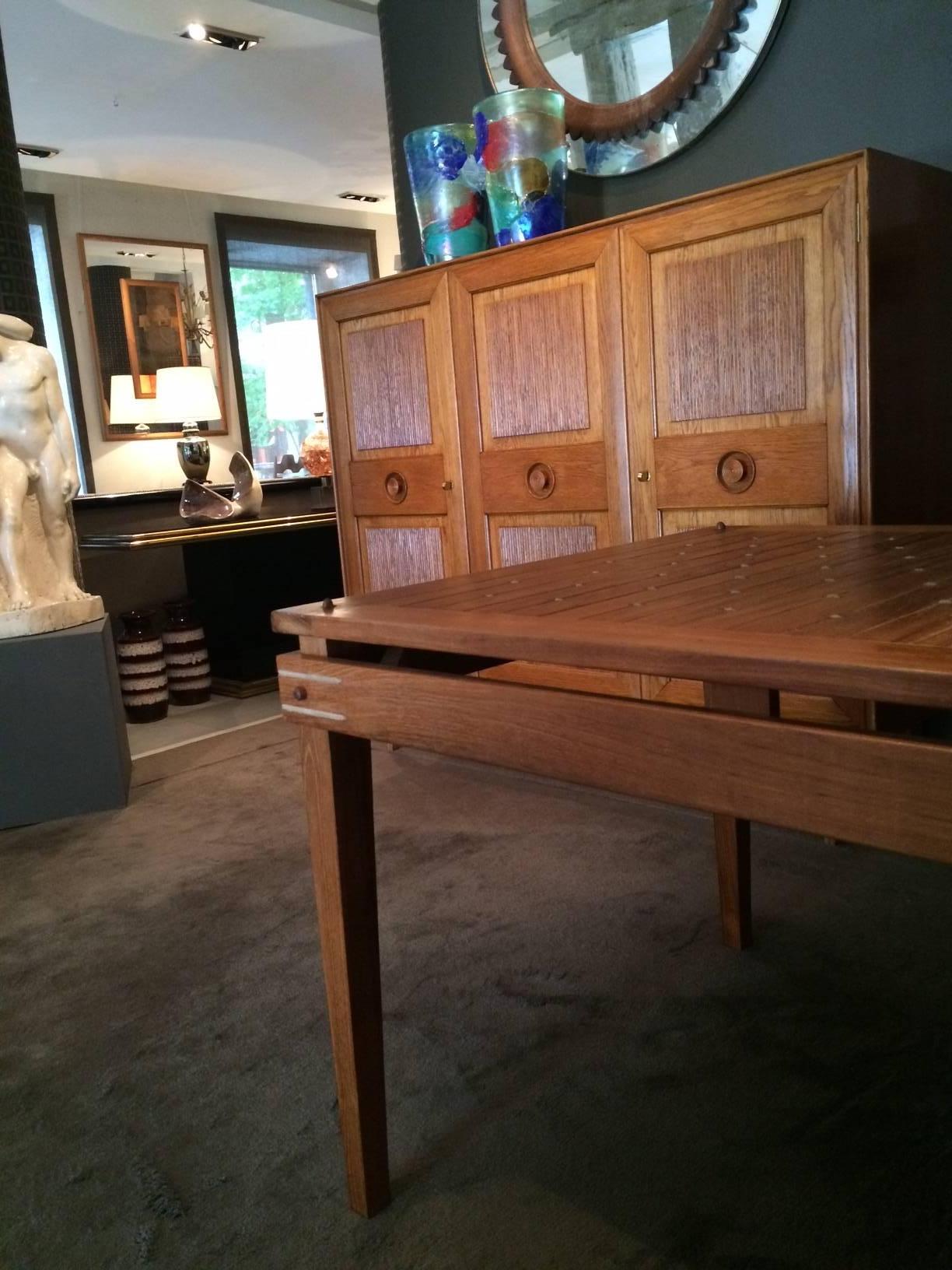 A walnut dining or centre table, decorated with pass-through rope-work.
 