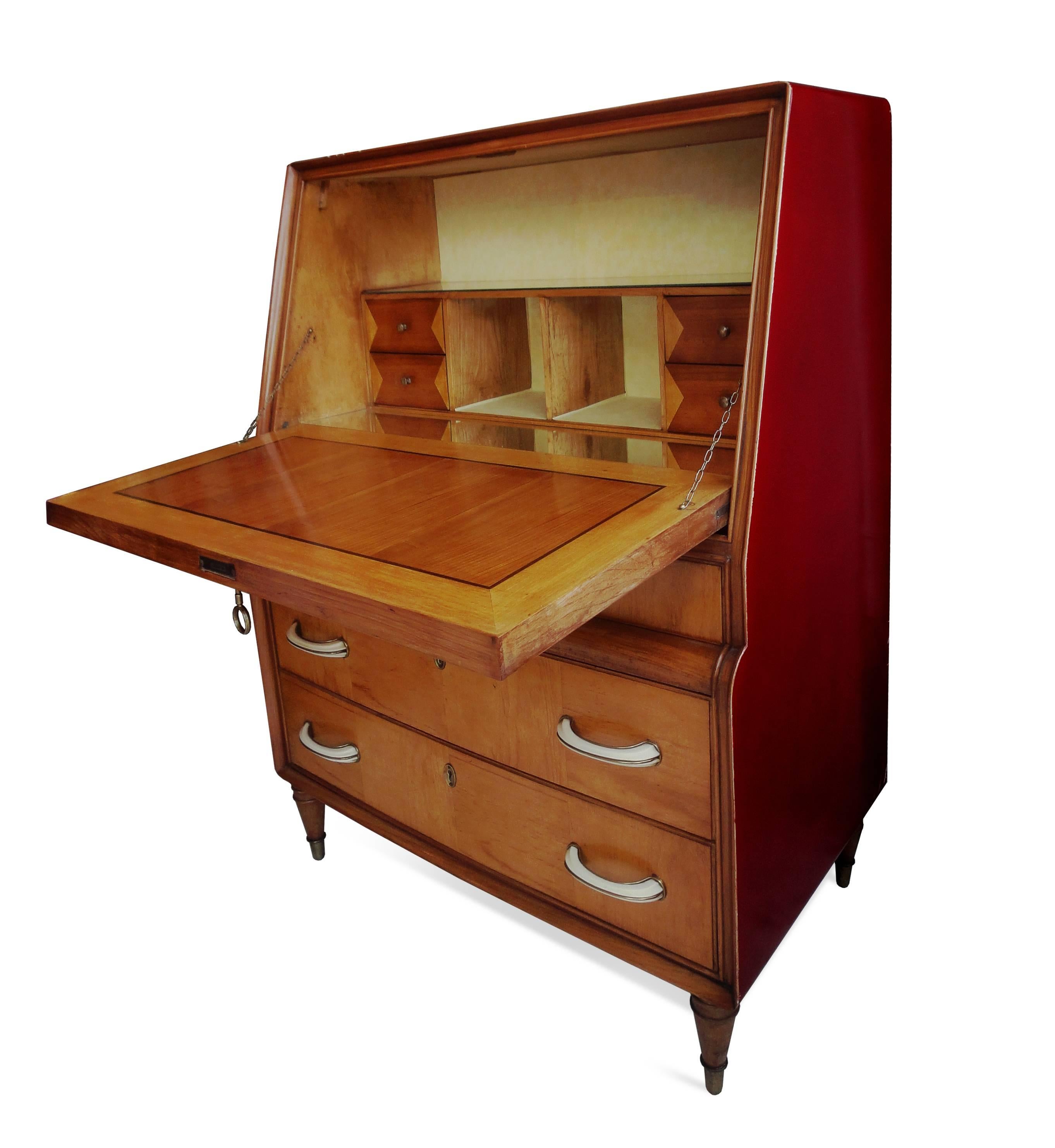 A red-lacquered “cabinet en abattant” with a satin-wood front, a glass interior and horn drawer-knobs.