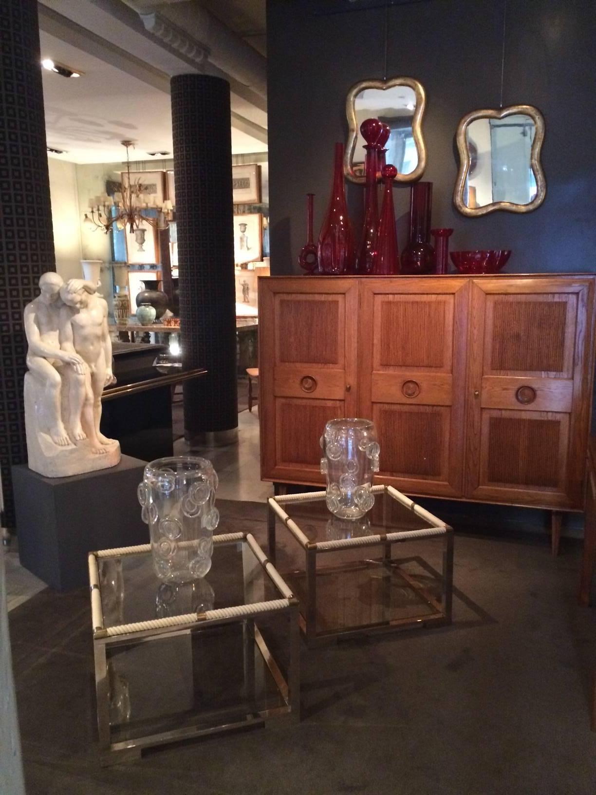 A pair of giltwood framed mirrors in the shape of clovers.
 