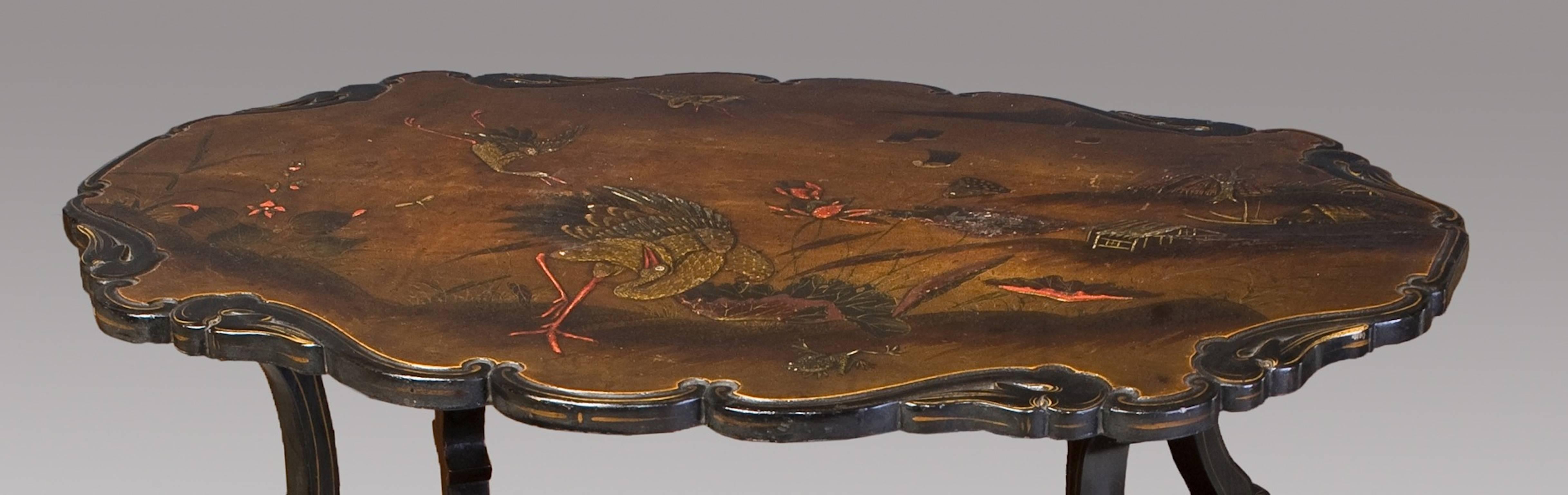 French lacquered two-tier Table. With birds in a landscape decoration.

