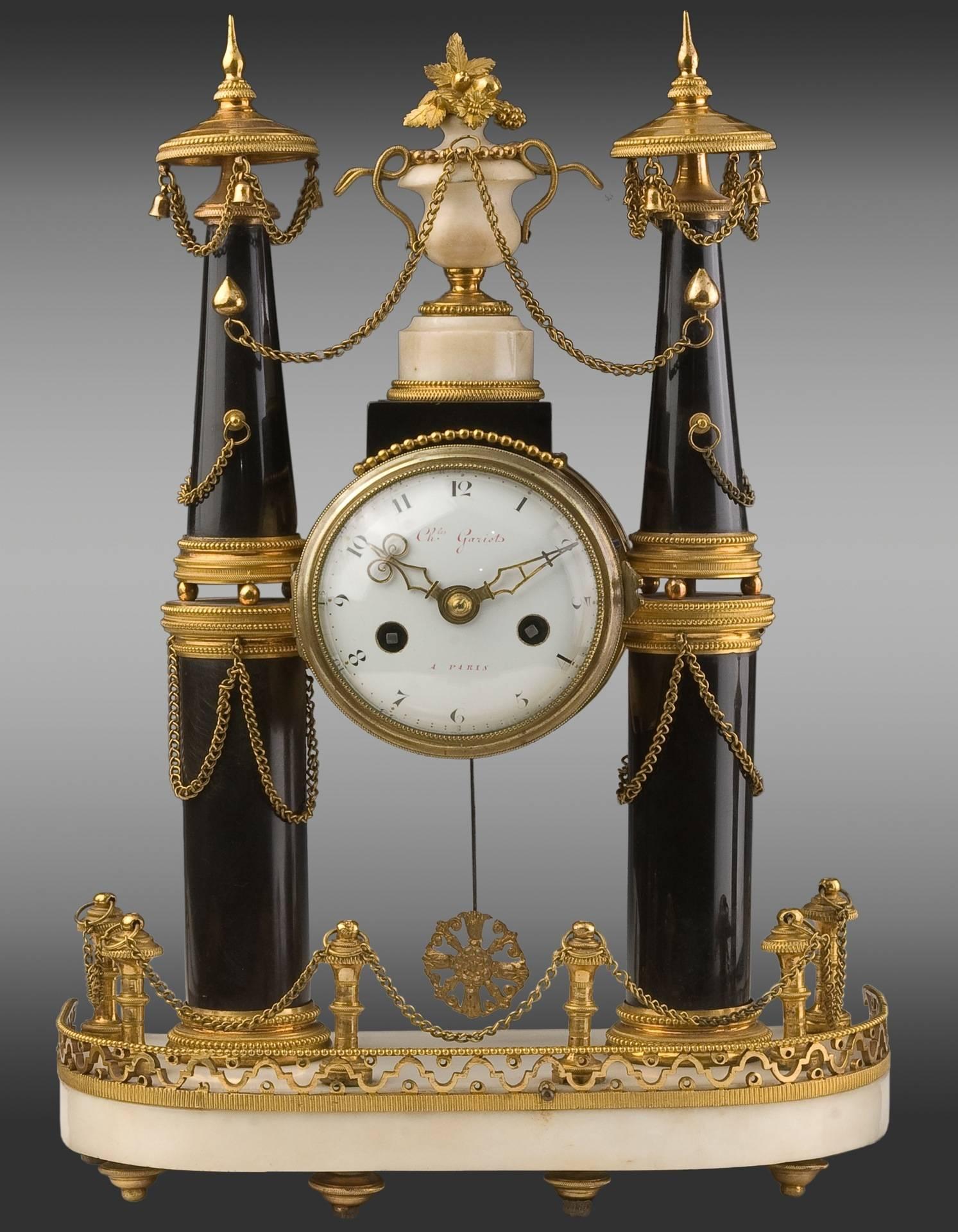 Gilt bronze marble clock and candlesticks. Louis XVI Period.
Dial signed:”Charles Garriots à Paris.”

