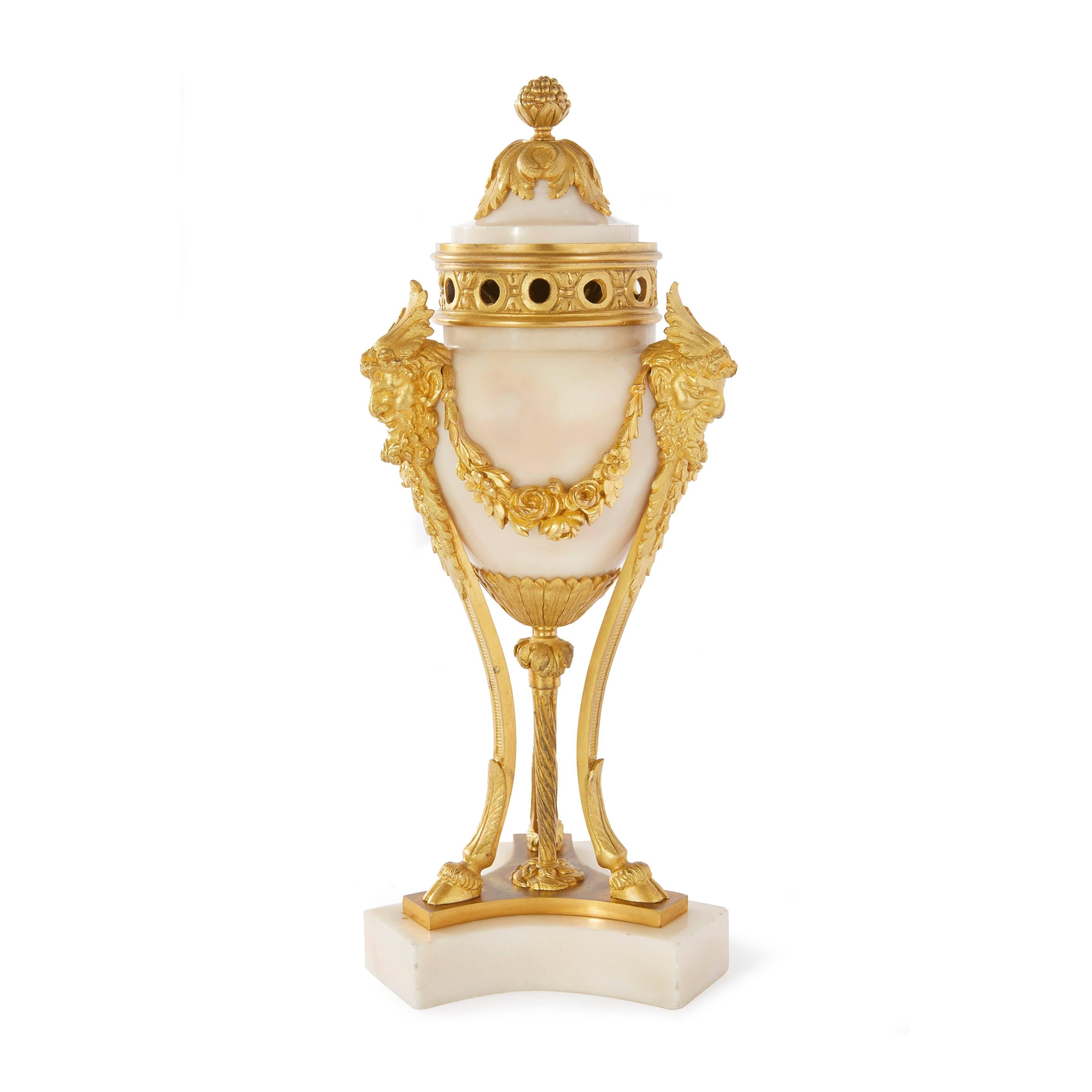 Each converting to three-light candelabra with pierced collars and foliate sconces on ovoid bodies and cabriole supports. 

These unusual cassolettes can be transformed into a pair of fine candelabra, making them an intriguing addition to any