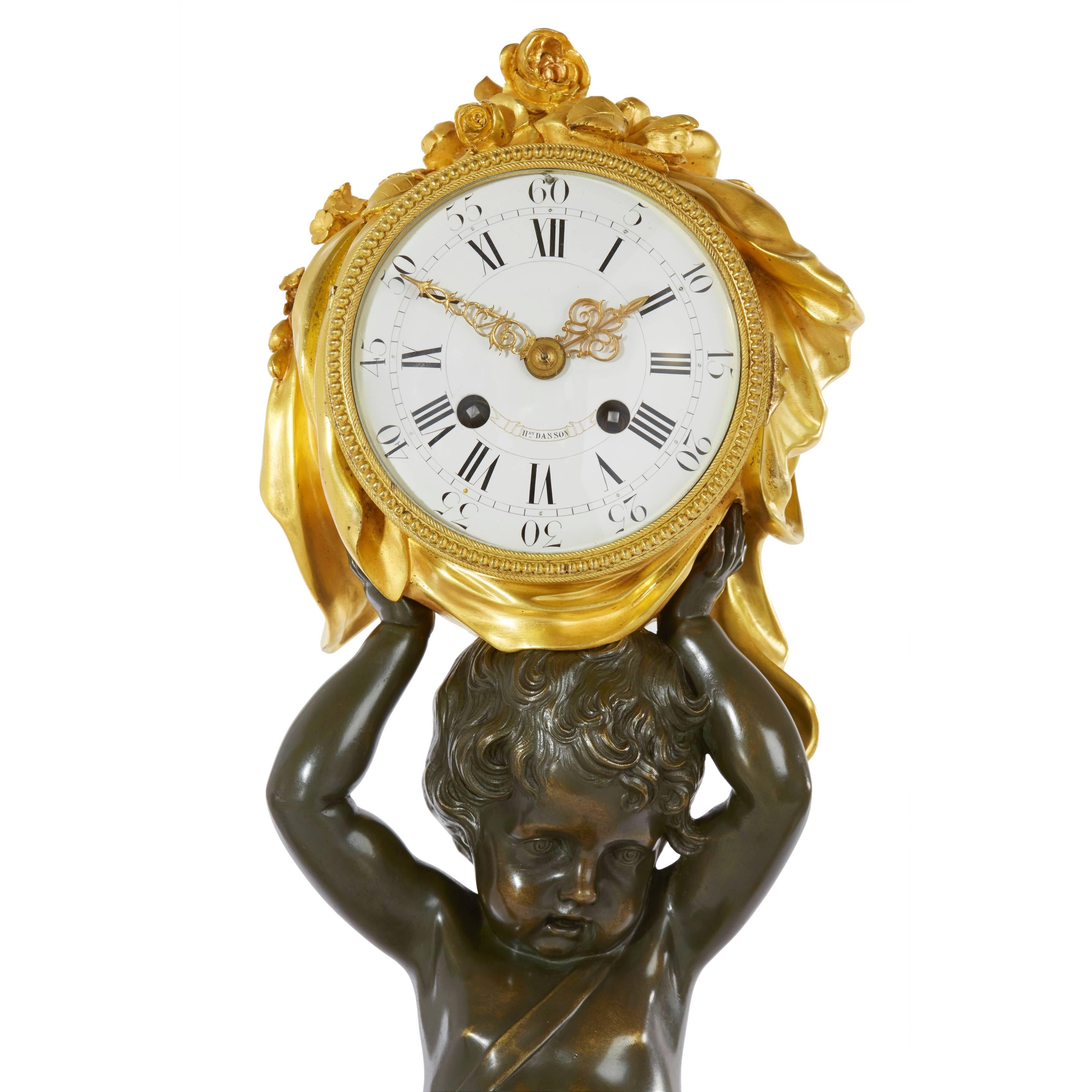 Comprising a central clock and a pair of flanking three-light candelabra, the clock with circular dial signed 'H. Dasson' in an ormolu case held aloft by a putti on one knee on a porphyry and ormolu base, the candelabra similarly decorated, each