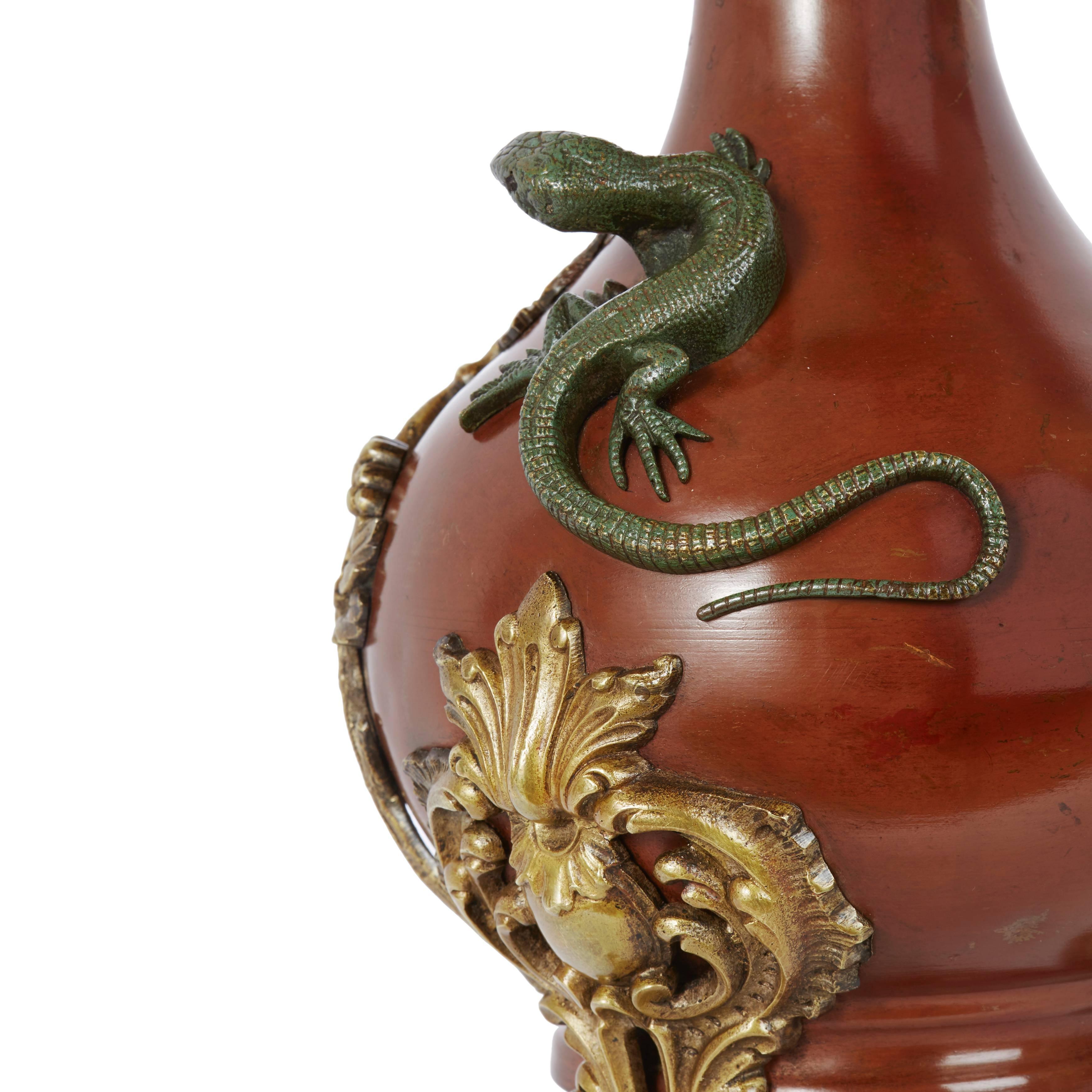 With an Arabesque rim and decorated with lizards, dragonflies and vines. 

These unusual vases reflect the European fascination Japan at the turn of the century and delightfully incorporate lizards and dragonflies.