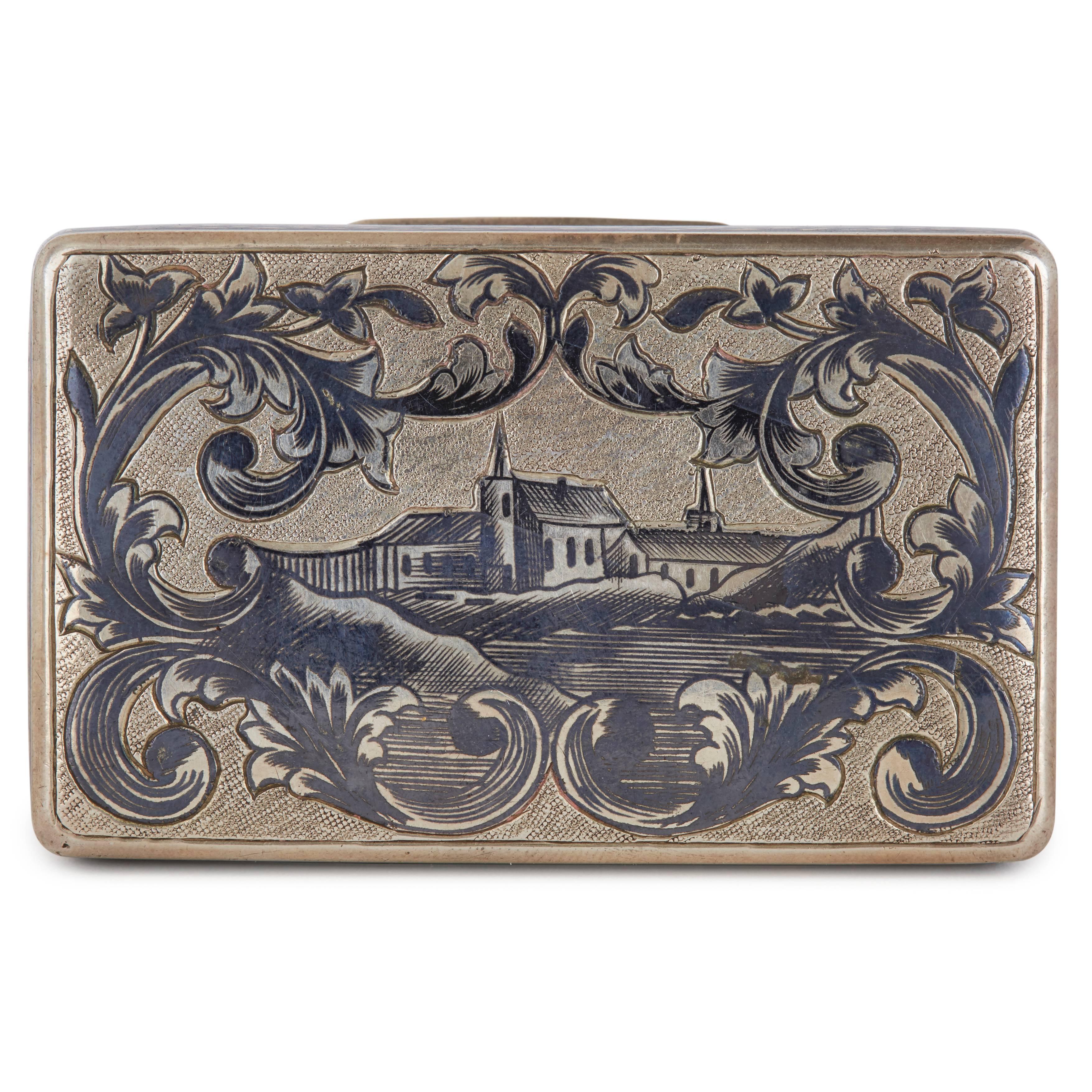Scene of Russian town surrounded by floral detailing on lid, lozenge design to sides.
