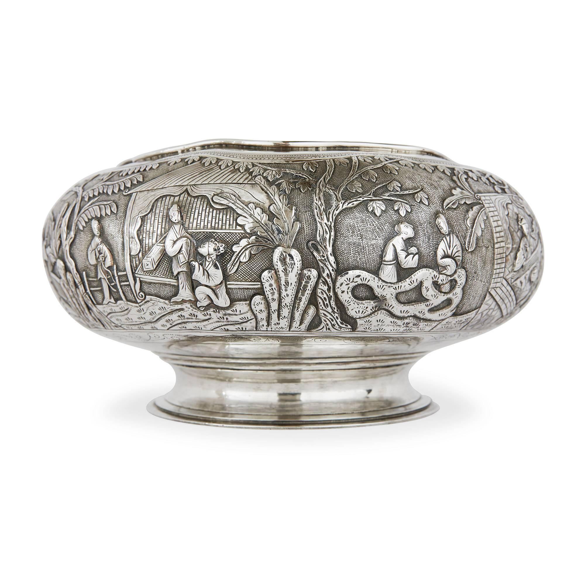Embossed detailing of outdoor garden scenes with amorous couples, raised on a short waisted socle, the base inscribed 'Jiaozho, Chengde'.

This extensively detailed antique bowl is an example of the very finest quality of silver produced in China