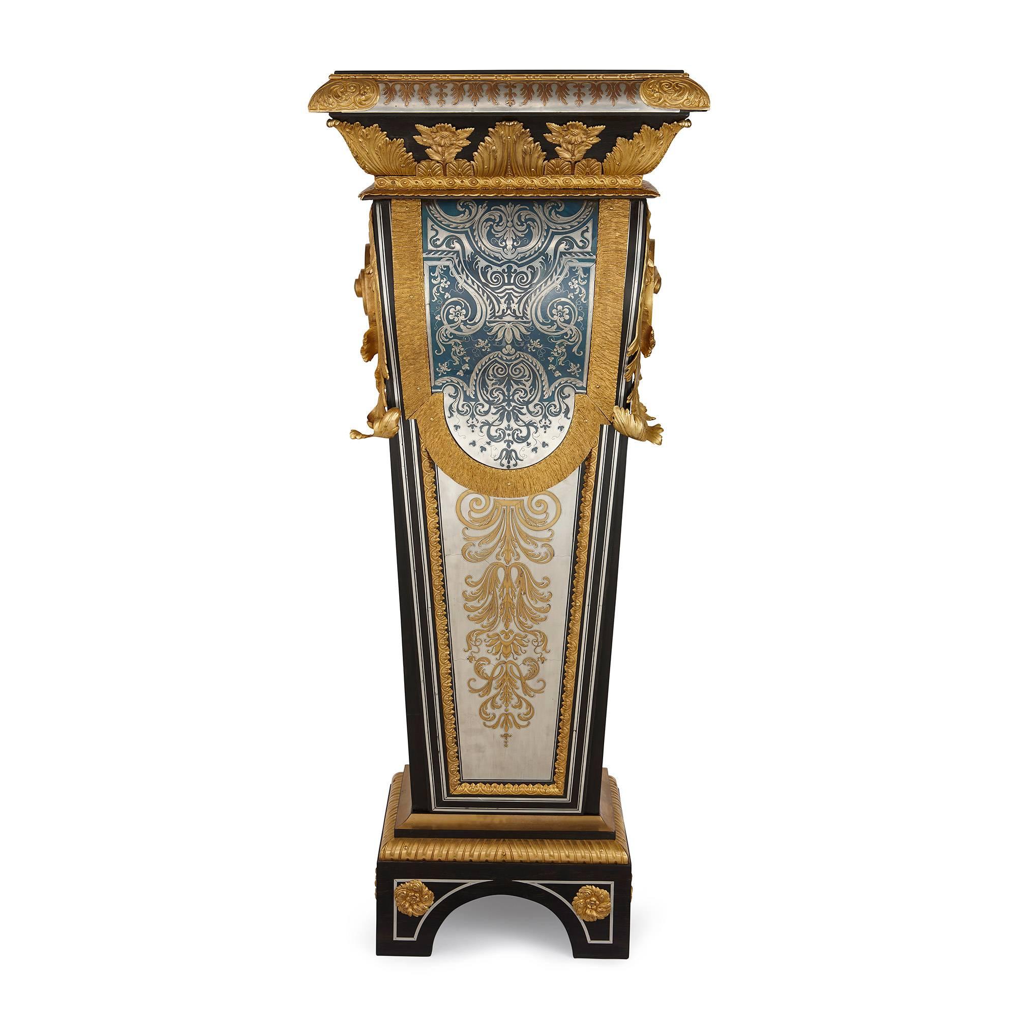 Of rectangular form with ebony, ebonized wood, inlaid pewter, brass and tinted blue horn mounted with fine quality ormolu mounts, elaborately decorated with geometric designs, flanked on the sides with large ormolu acanthus scrolls, on arched