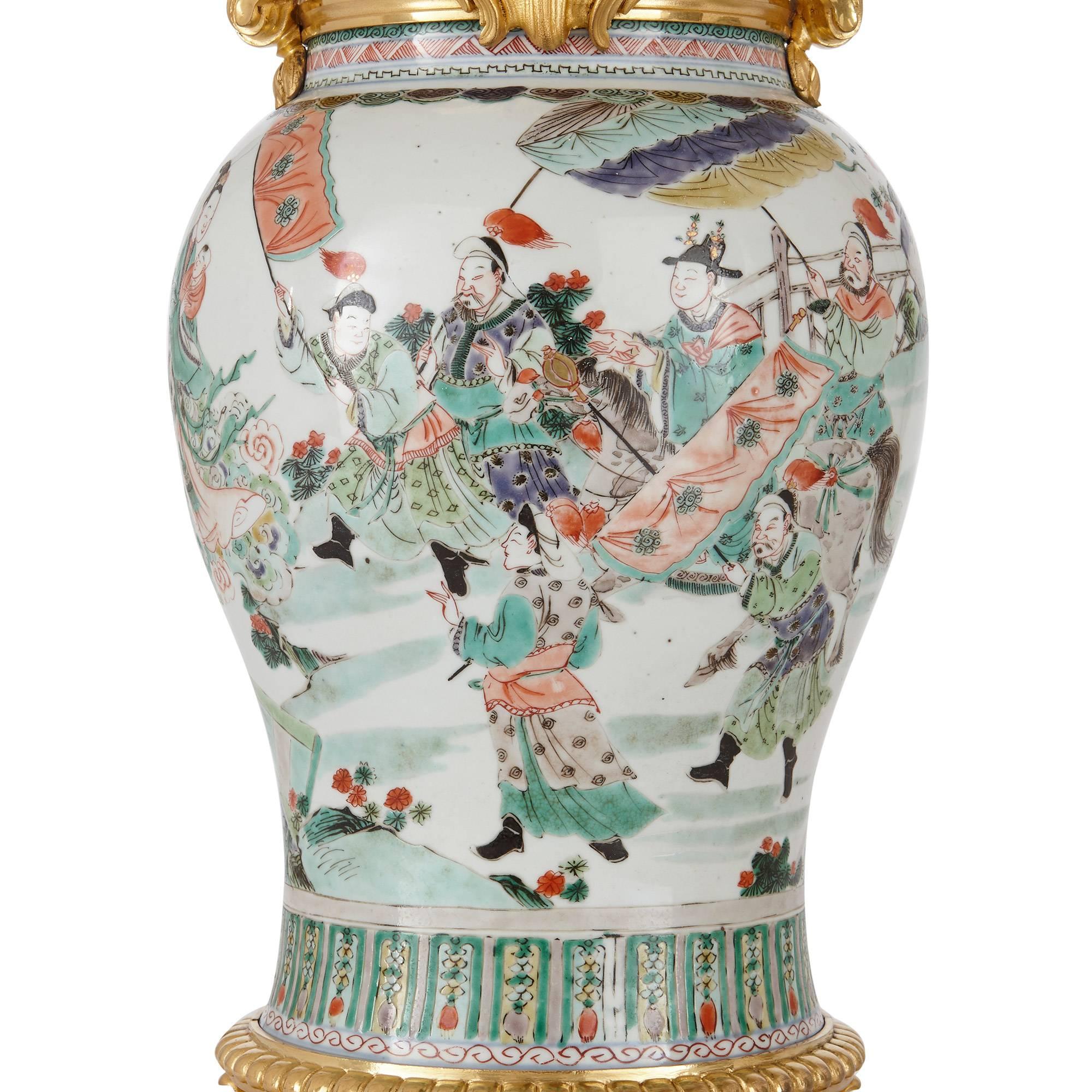 The ormolu French, late 19th century by Henri Vian (French, 1860-1905); the porcelain Chinese, early 18th century, Kangxi period.

Each of baluster form decorated with a procession of a figure on horseback with attendants in gardens and an