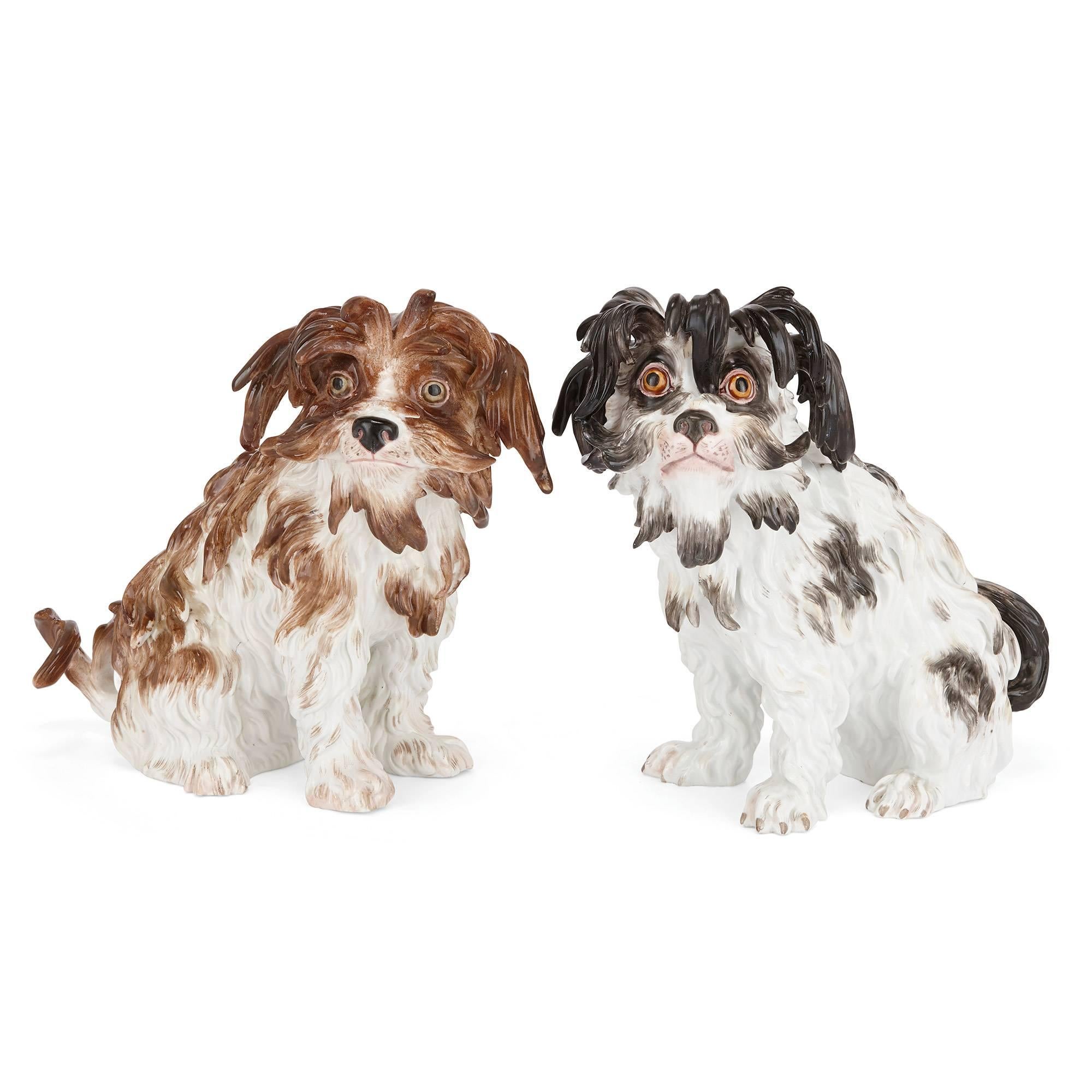 One dog with black and white fur, the other brown and white fur, both with relief moulding to the body, the bases marked in underglaze blue with inscribed marks of Meissen.

These charming model dogs, each depicted in impressive naturalistic