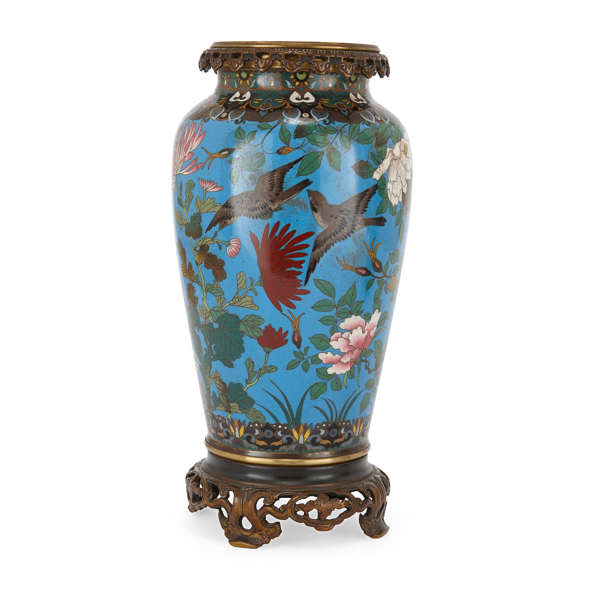 Of ovoid form with a pierced ormolu rim, decorated throughout with birds, flowers and foliage, raised on pierced ormolu feet; the enamel Japanese, the ormolu French, late 19th century.

These exquisite Japanese vases were crafted during the Meiji