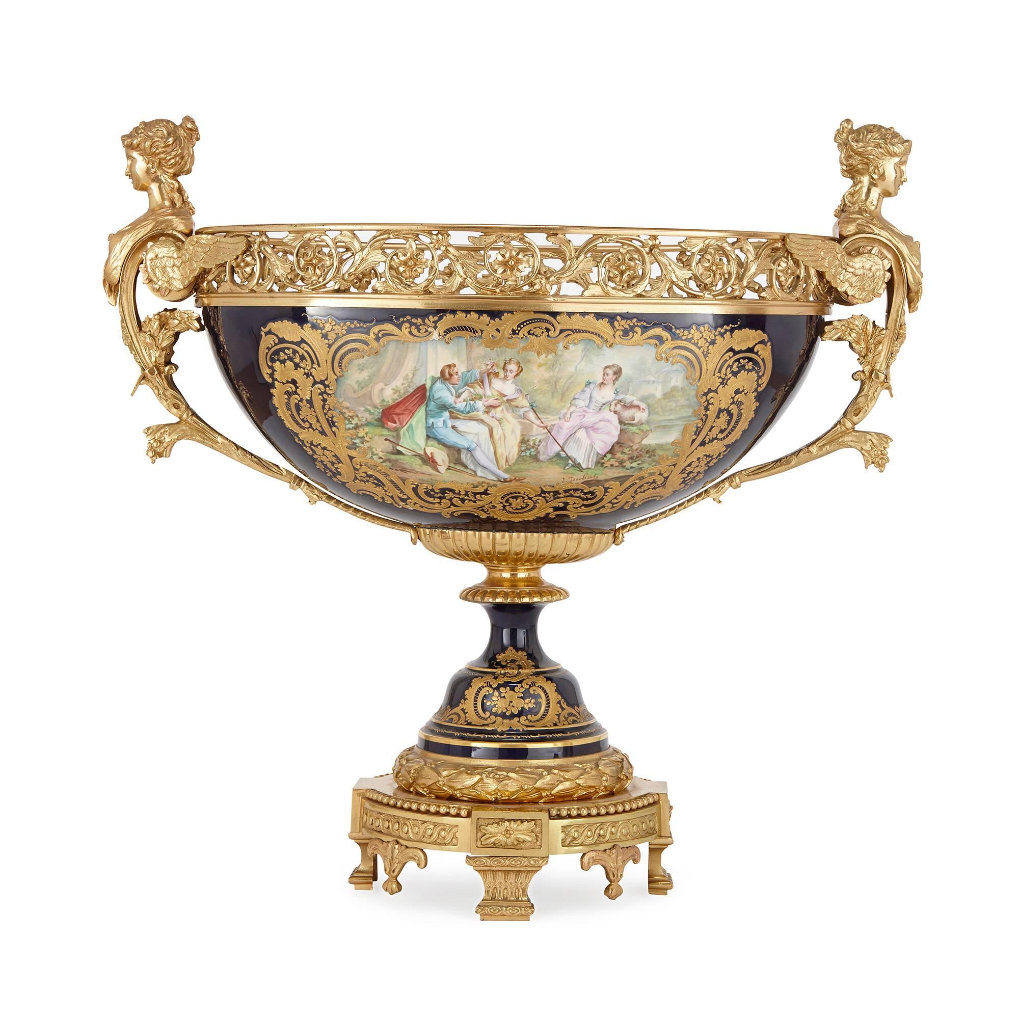 Each with domed cover surmounted by an ormolu pineapple finial, the body parcel-gilt on royal blue ground, painted with opposing figural scenes to the front signed 'J Dubut' and landscape scenes to the reverse, with twin ormolu caryatid form