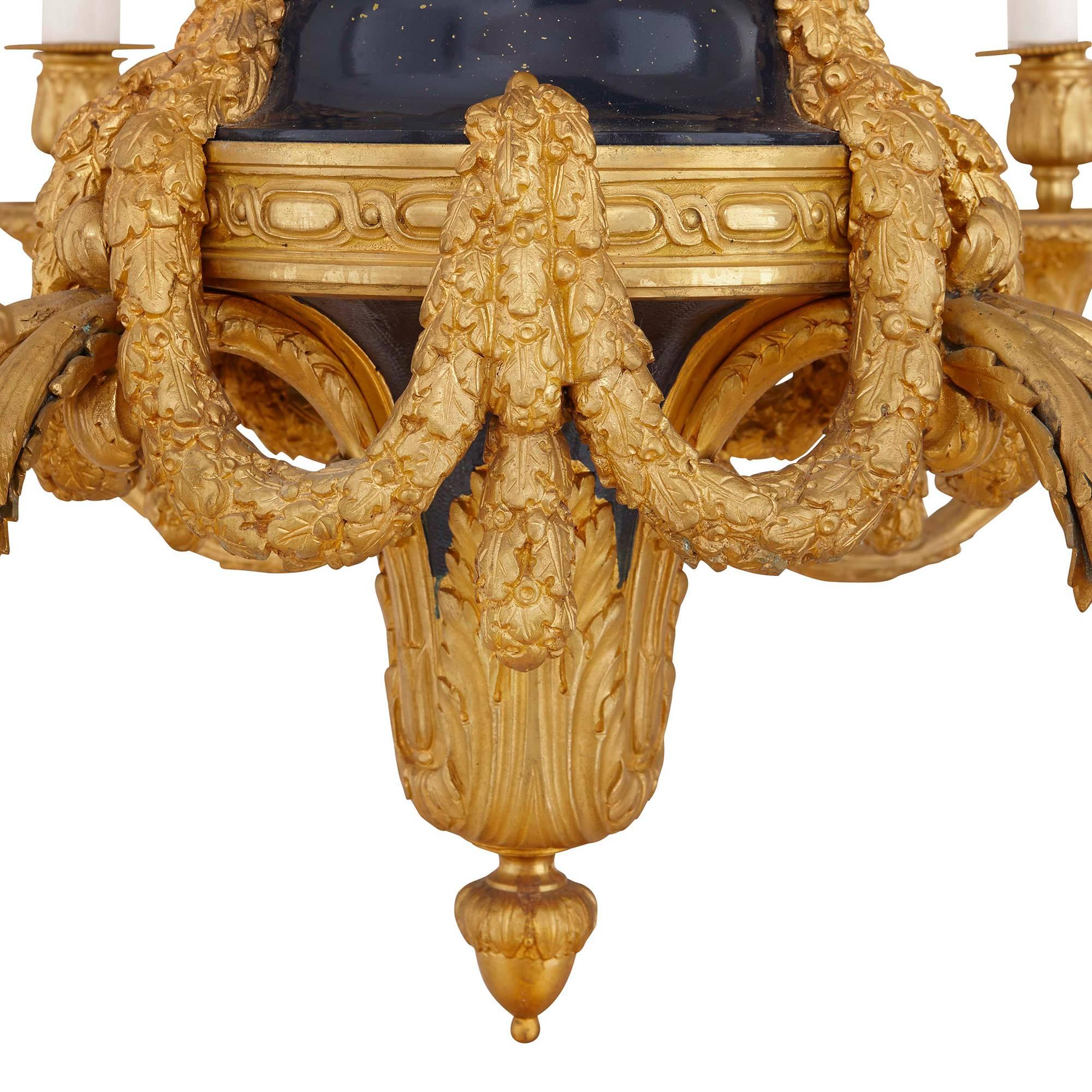 Gilt French Belle Époque style gold ormolu and blue detail nine light chandelier For Sale