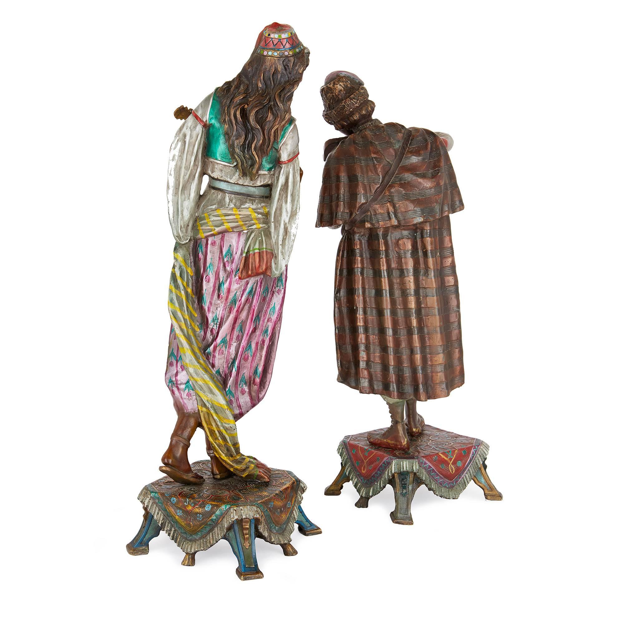 The figures representing a male and female in colored clothing, playing the violin and the mandolin respectively, each standing on a plinth.

These bronze Orientalist style figures, each holding a musical instrument, capture the jovial spirit of