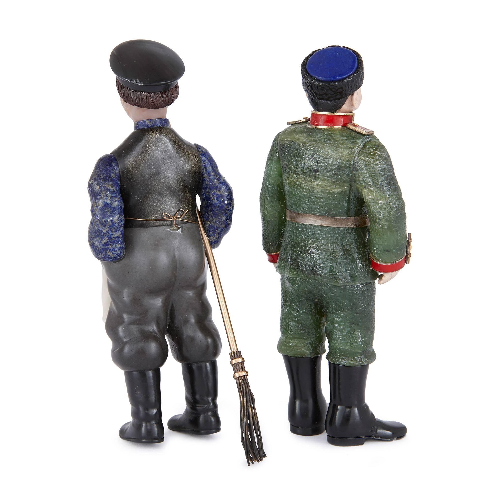 One figure in a blue uniform with a black peaked cap, holding a broom; the other figure in a Soviet style soldier's uniform with a fur hat.

These charming Russian figures are carefully crafted from precious hardstones in the Fabergé style, making