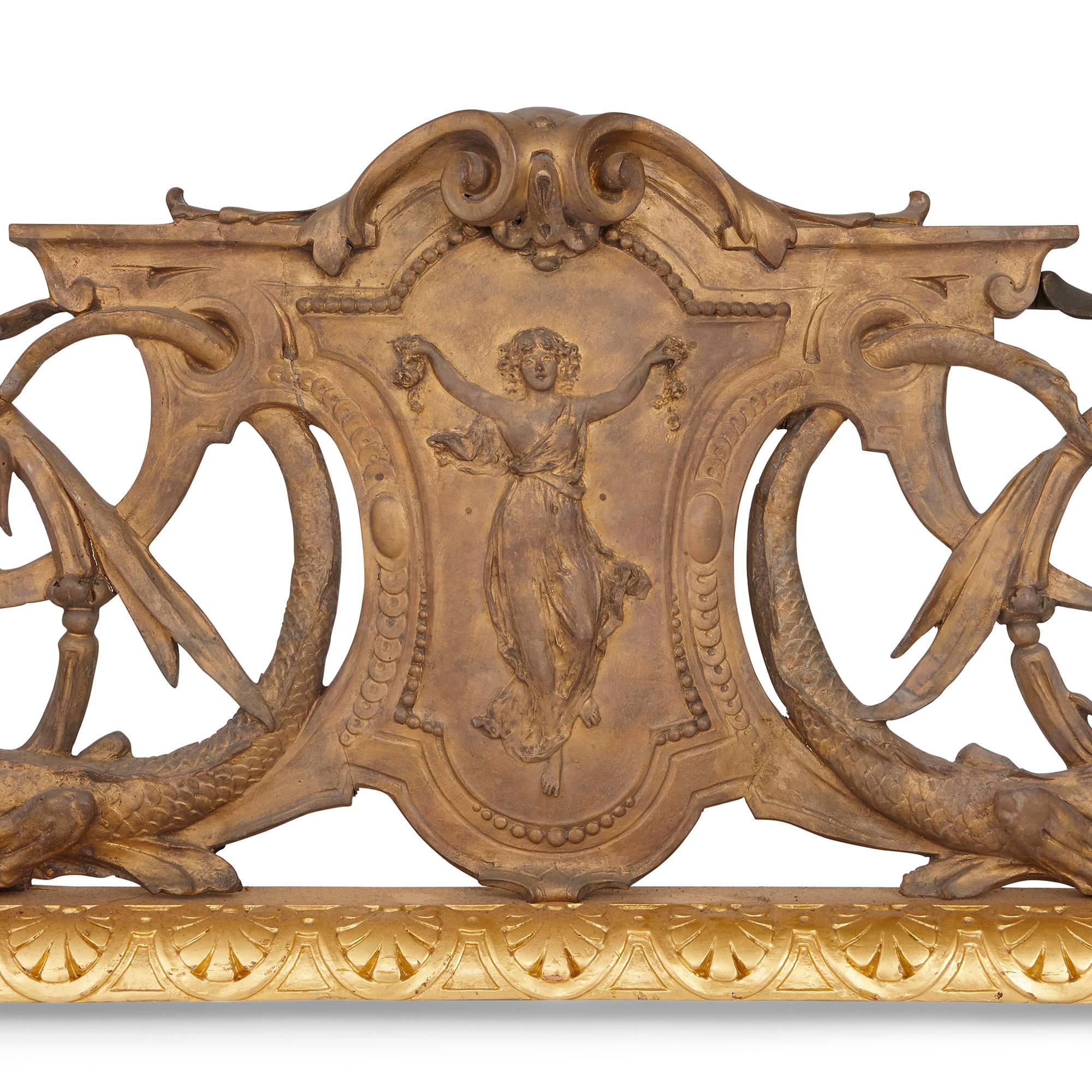 This stunning antique French fireplace is unusual for its stylistic fusion, which combines motifs from a range of different design periods.

Most striking are the neo-Gothic depictions of dragons, which sit at either end of the fender. These take