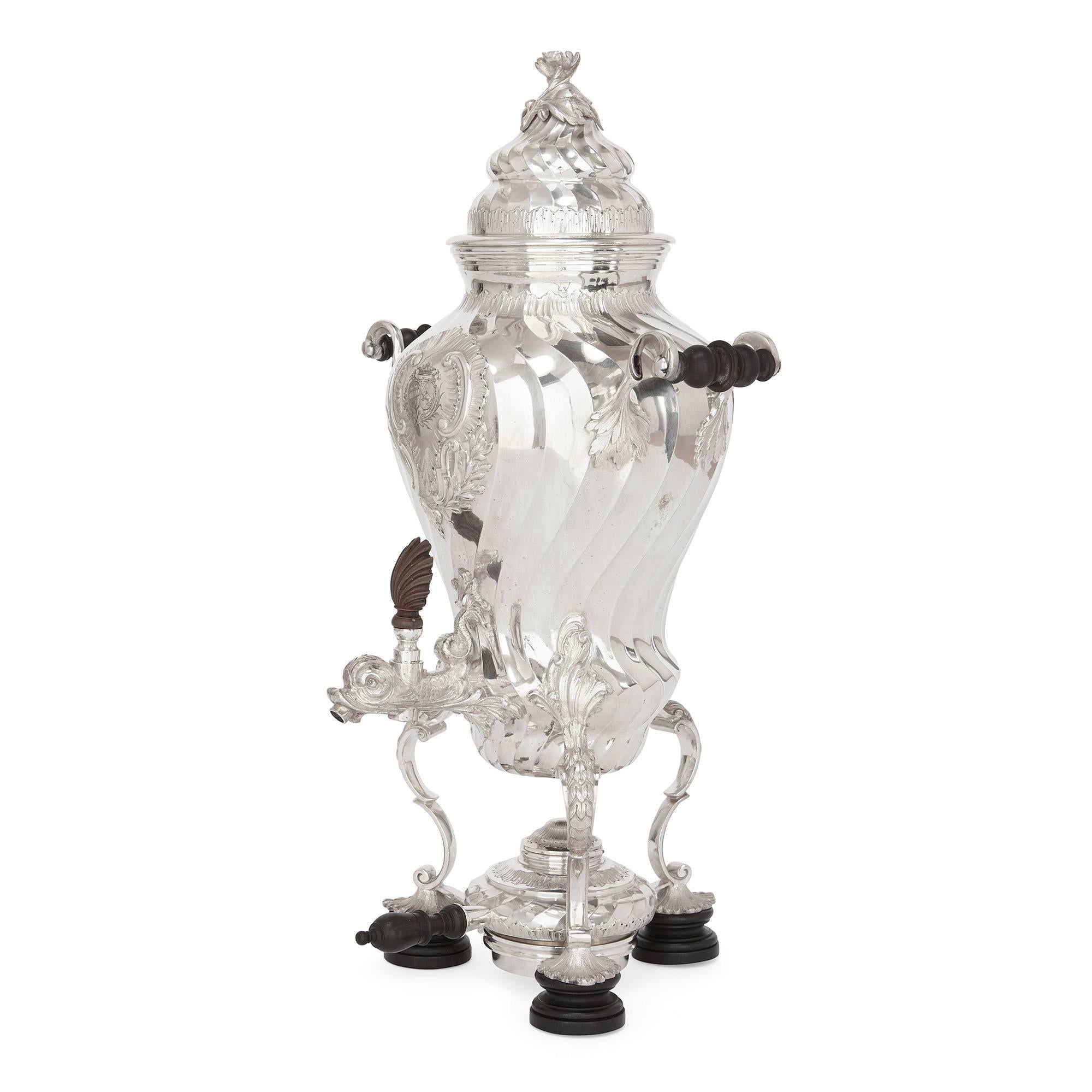 This stunning antique silver tea and coffee set consists of: one silver coffee pot with a wooden handle; one silver tea pot with a wooden handle; one silver cream just with a wooden handle; one silver sugar bowl with gilt inside; one silver-plated