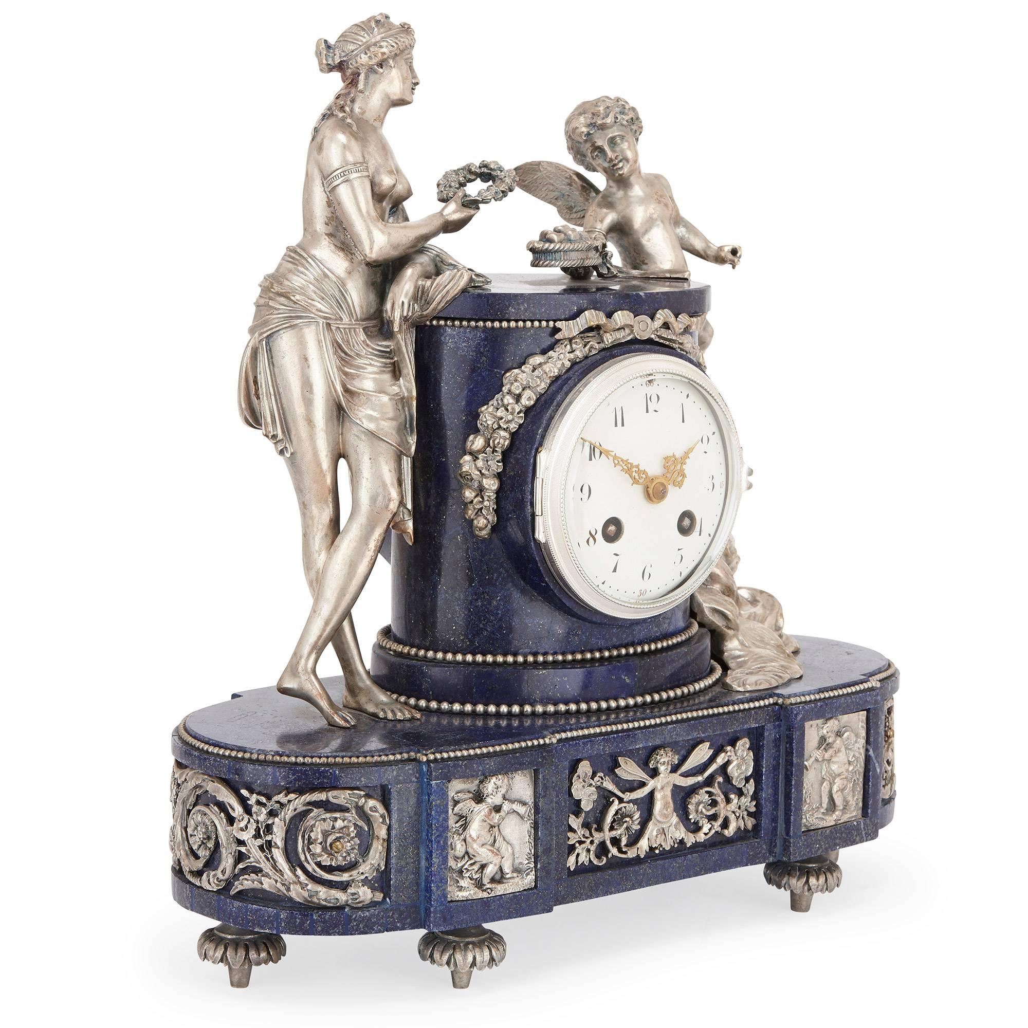 This beautiful antique three-piece French clock set is comprised of a central clock and a pair of flanking candelabra. 

The central clock features a circular central dial surrounded by a lapis lazuli case and decorated with a silvered bronze