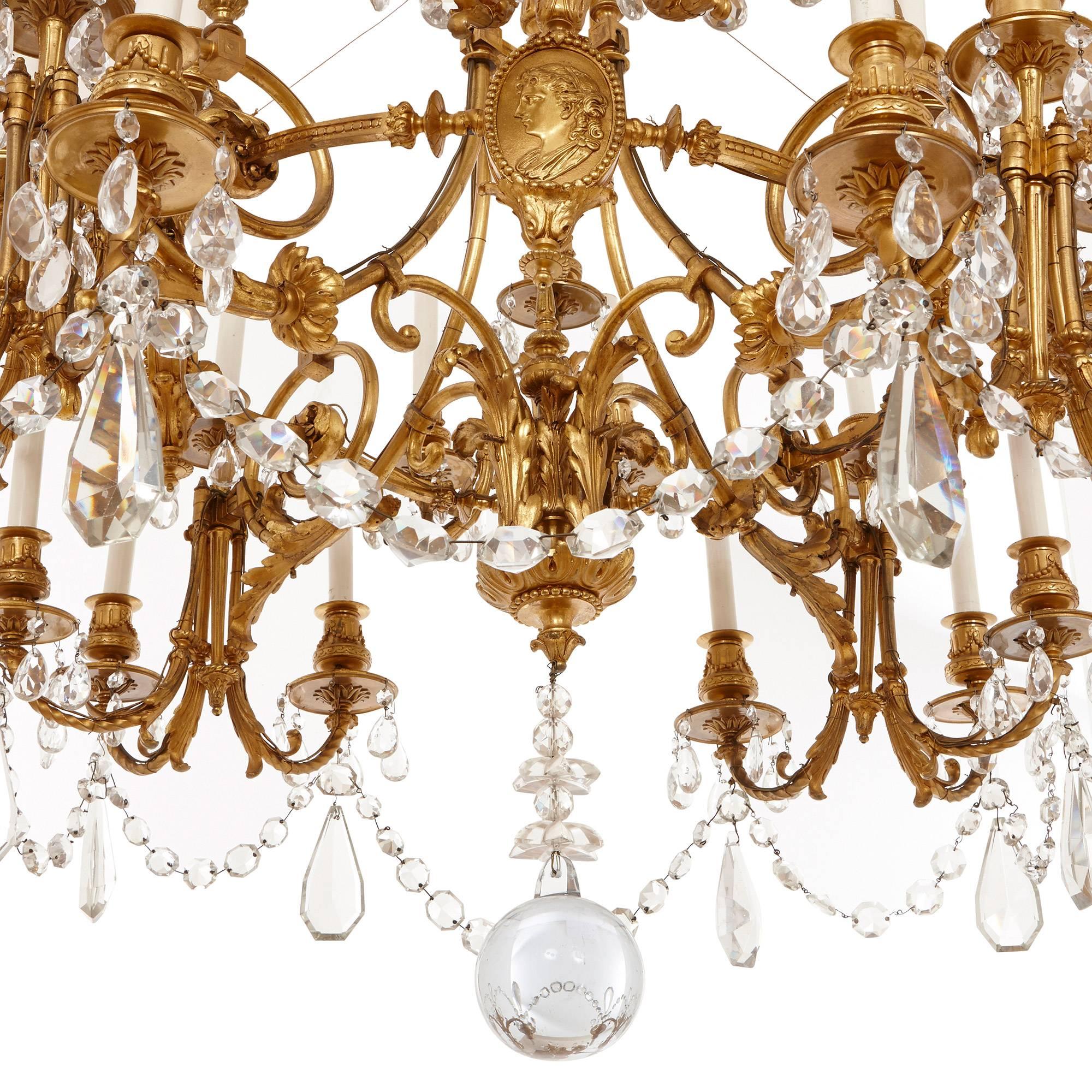 This beautiful antique chandelier, featuring exquisitely cut hanging glass droplets, would make an impressive addition to any interior space. The French chandelier is extensively detailed throughout, with four seated cherubs playing instruments