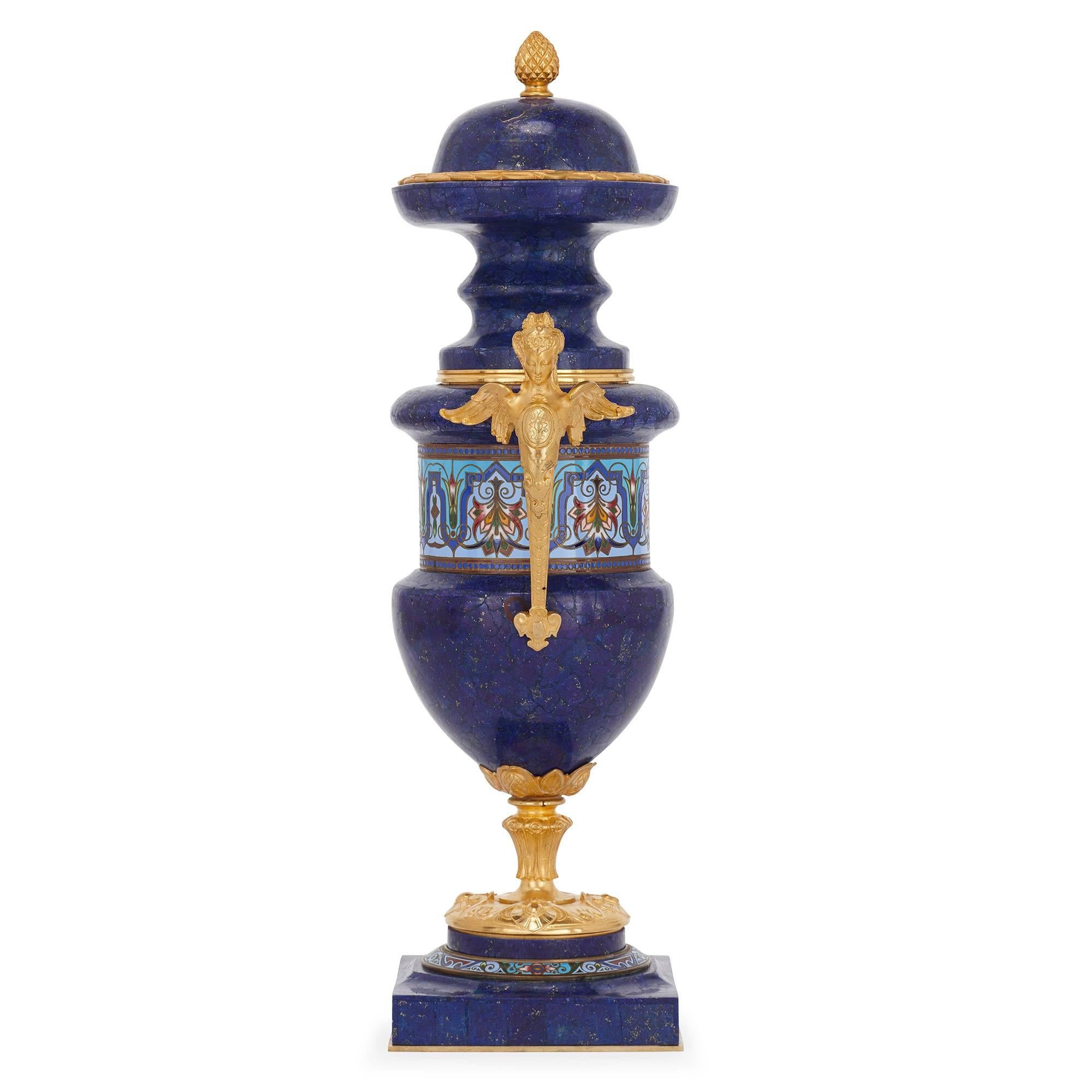 These exquisite neoclassical style vases are crafted from precious lapis lazuli, a gemstone highly prized since ancient times on account of its vibrant blue coloring and rarity. The present antique vases are further embellished with champlevé enamel