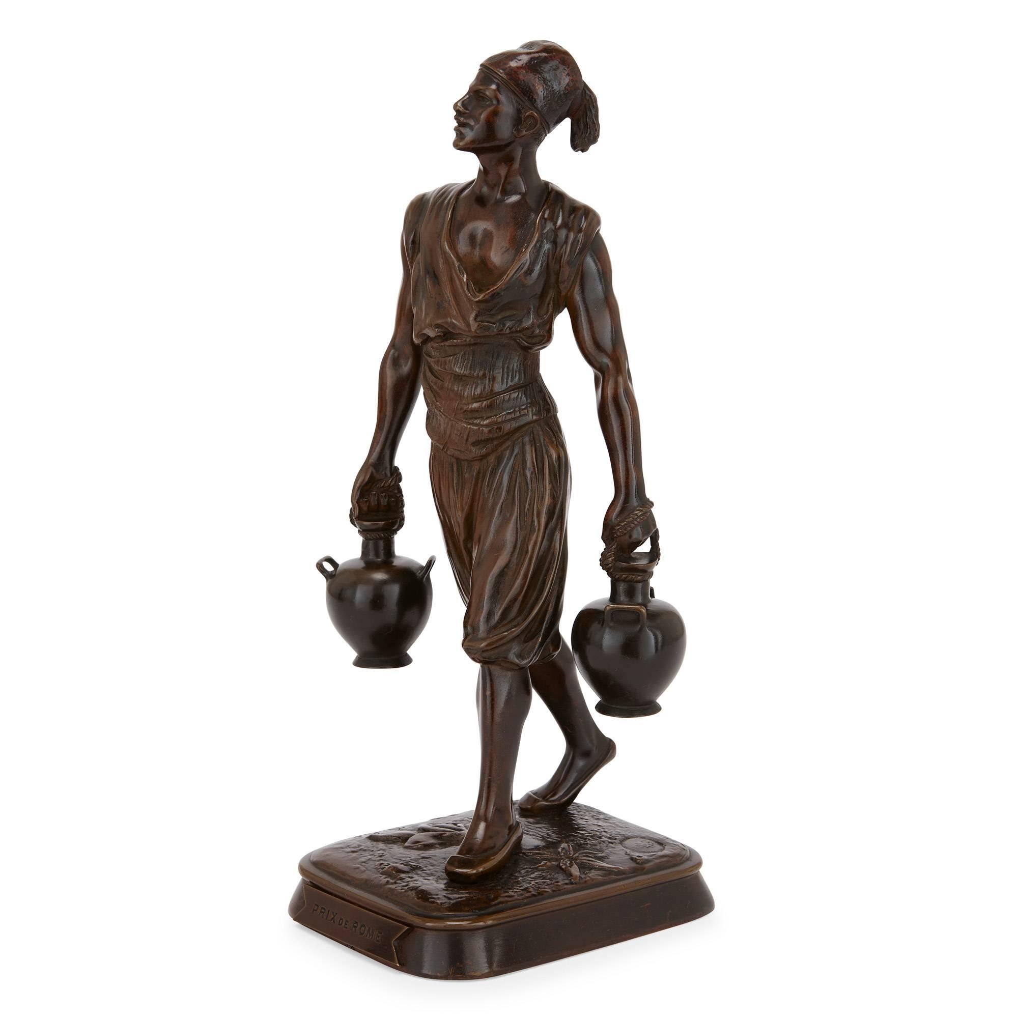 These charming antique Orientalist style figures were crafted by prestigious French makers Emile Pinedo (French, 1840-1916) and Marcel Debut (French, 1865-1933). One figure is modelled in the form of a Tunisian water carrier and the other is