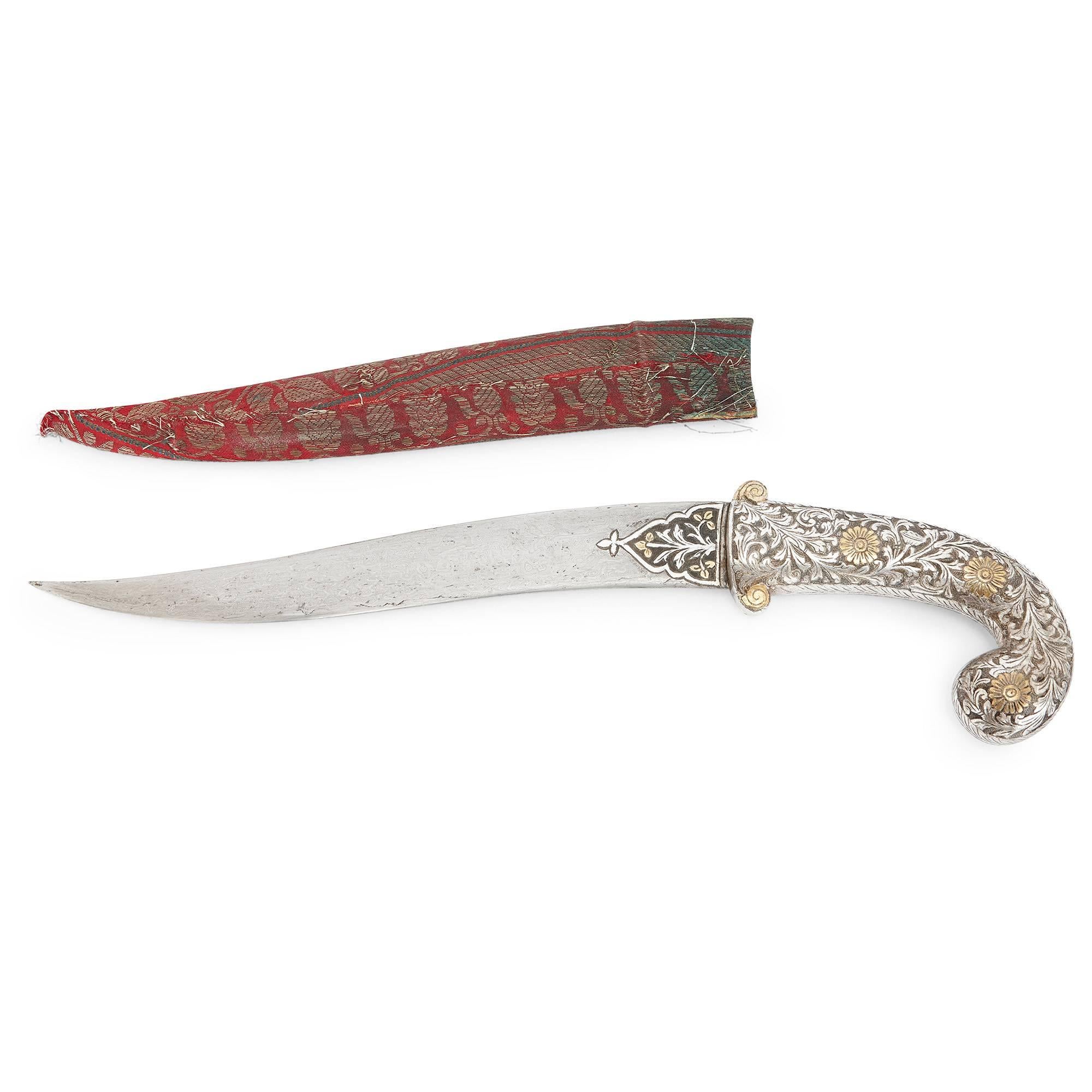 Featuring delicate gold inlay detailing in the Koftgari technique, this stunning antique dagger (Khanjar) is a brilliant example of high quality 19th century Indian craftsmanship. The dagger hilt is decorated with engraved patterns of floral and