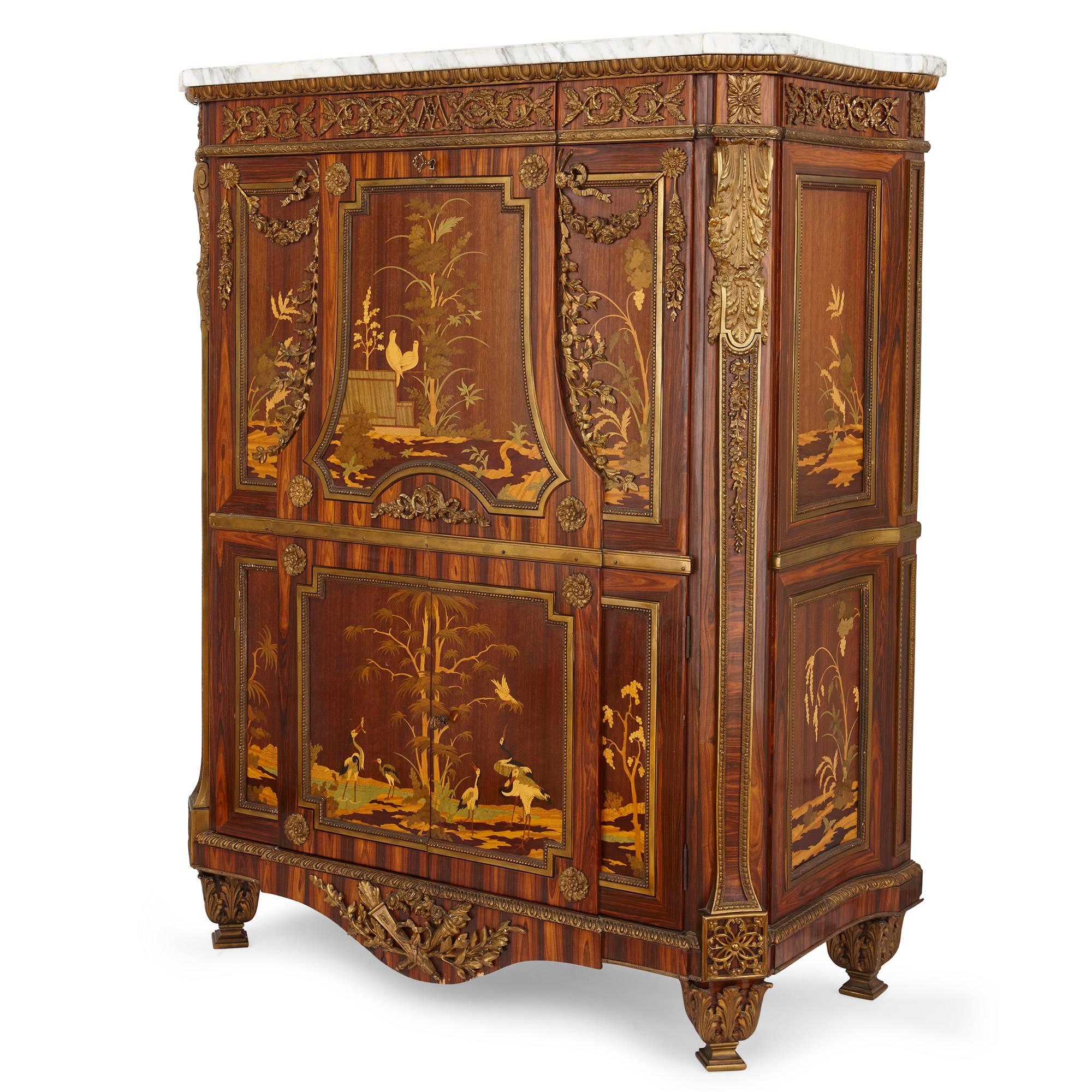 This fine antique secrétaire displays exceptional attention to detail, with exquisite marquetry detailing and gilt bronze mounts. The marquetry work is especially vibrant and is used to create impressive scenes of nature incorporating trees, plants,
